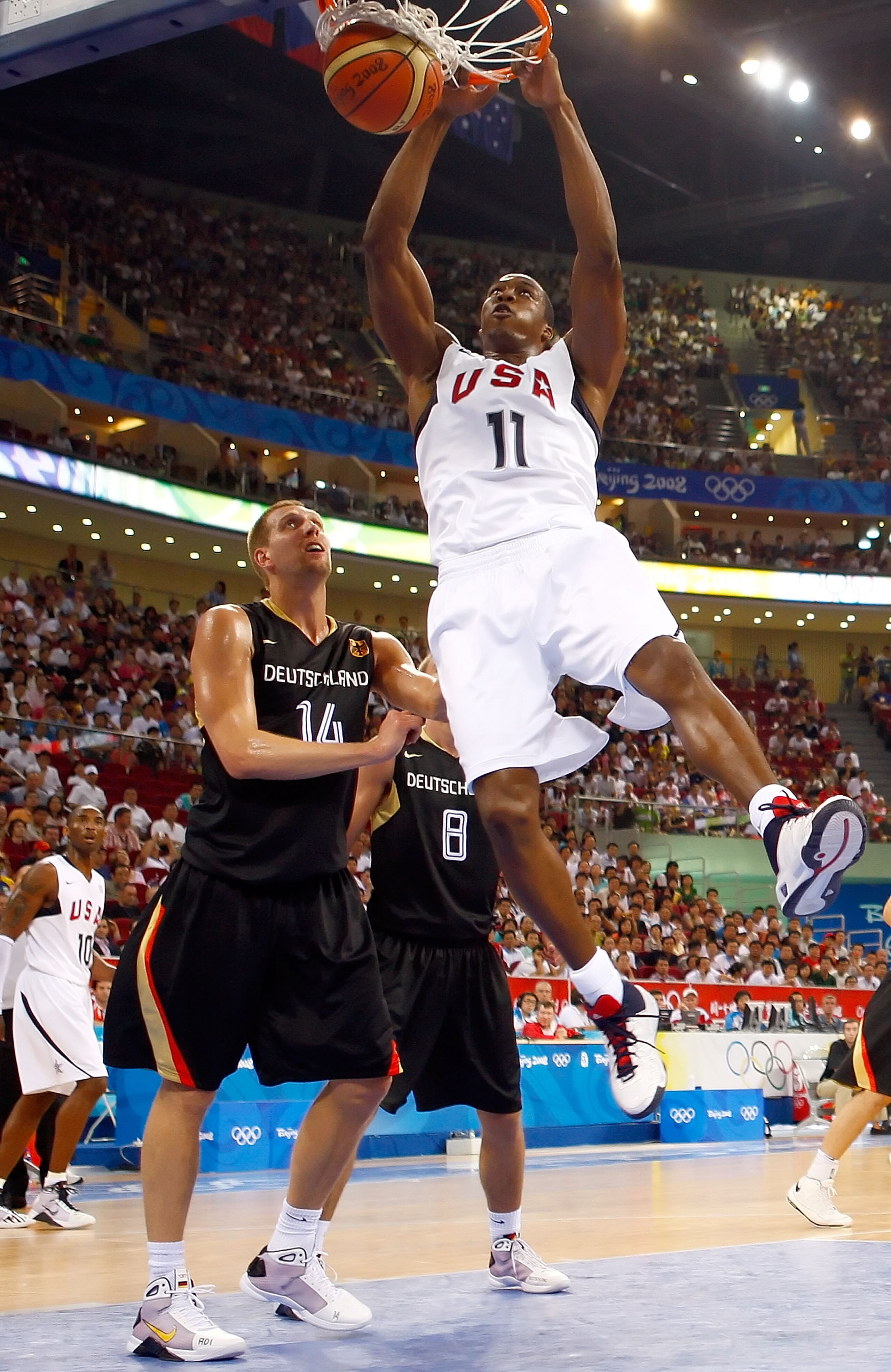BEIJING - AUGUST 18:  Dwight Howard #11 dunks over the defense of Dirk Nowitzki #14 of Germany during the men?s basketball preliminaries at the Wukesong Indoor Stadium on Day 10 of the Beijing 2008 Olympic Games on August 18, 2008 in Beijing, China.  (Pho