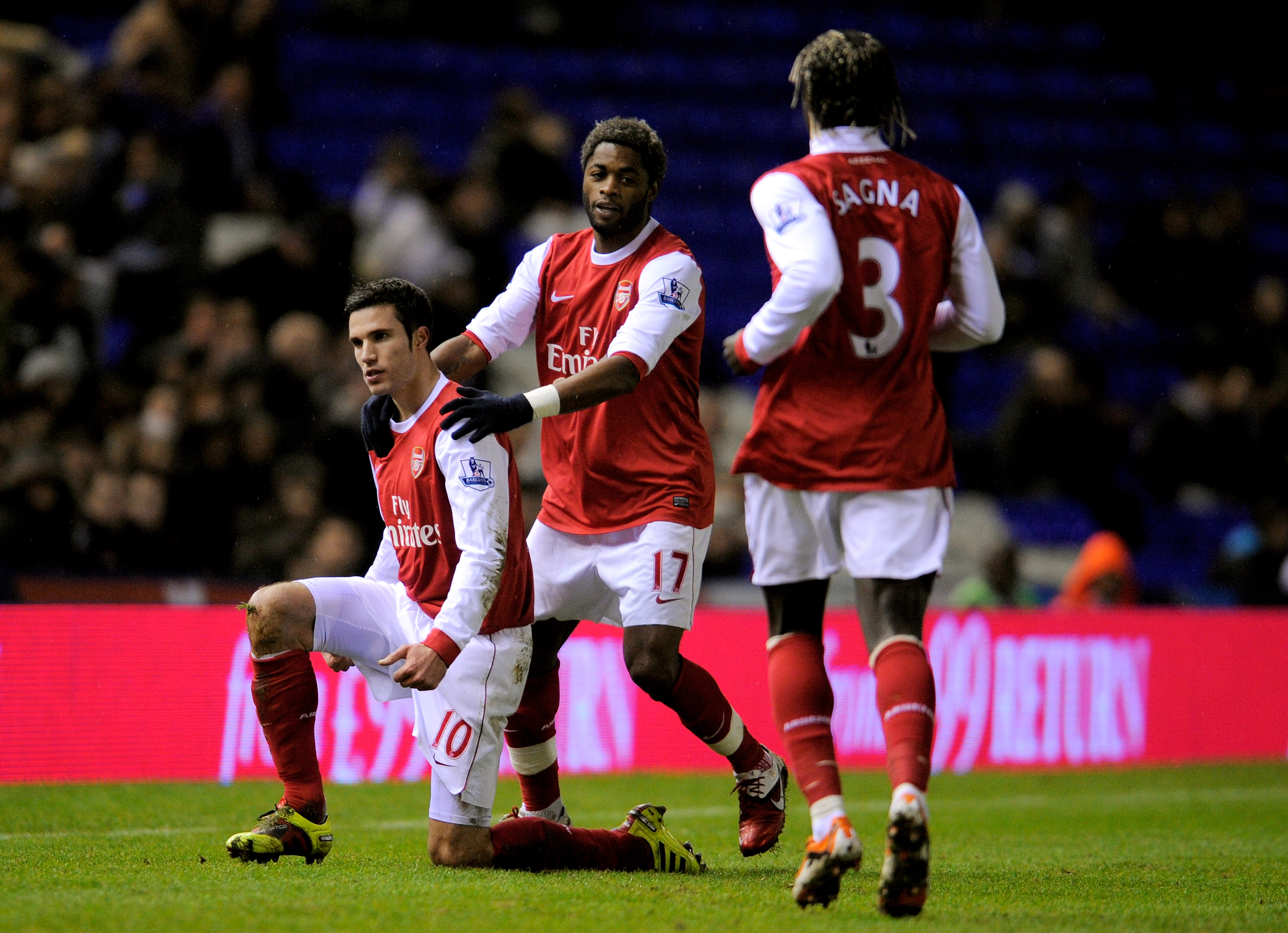 BIRMINGHAM, ENGLAND - JANUARY 01:  Robin Van Persie (L) of Arsenal is congratulated by teammates Alex Song (C) and Bacary Sagna (R) after scoring the opening goal of the match during the Barclays Premier Leaue match between Birmingham City and Arsenal at