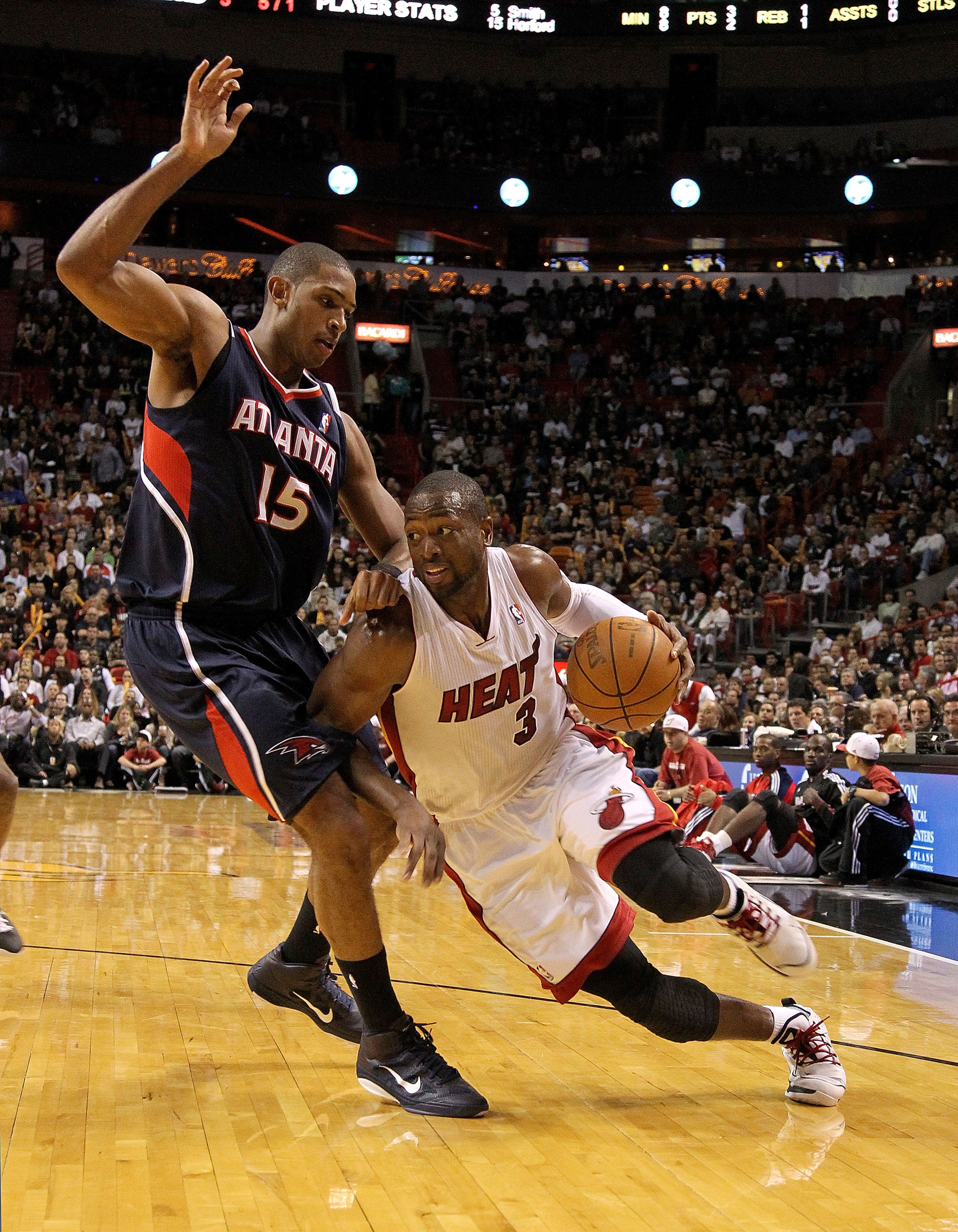 MIAMI, FL - DECEMBER 04:  Dwyane Wade #3 of the Miami Heat dribbles around Al Horford #15 of the Atlanta Hawks during a game at American Airlines Arena on December 4, 2010 in Miami, Florida. NOTE TO USER: User expressly acknowledges and agrees that, by do