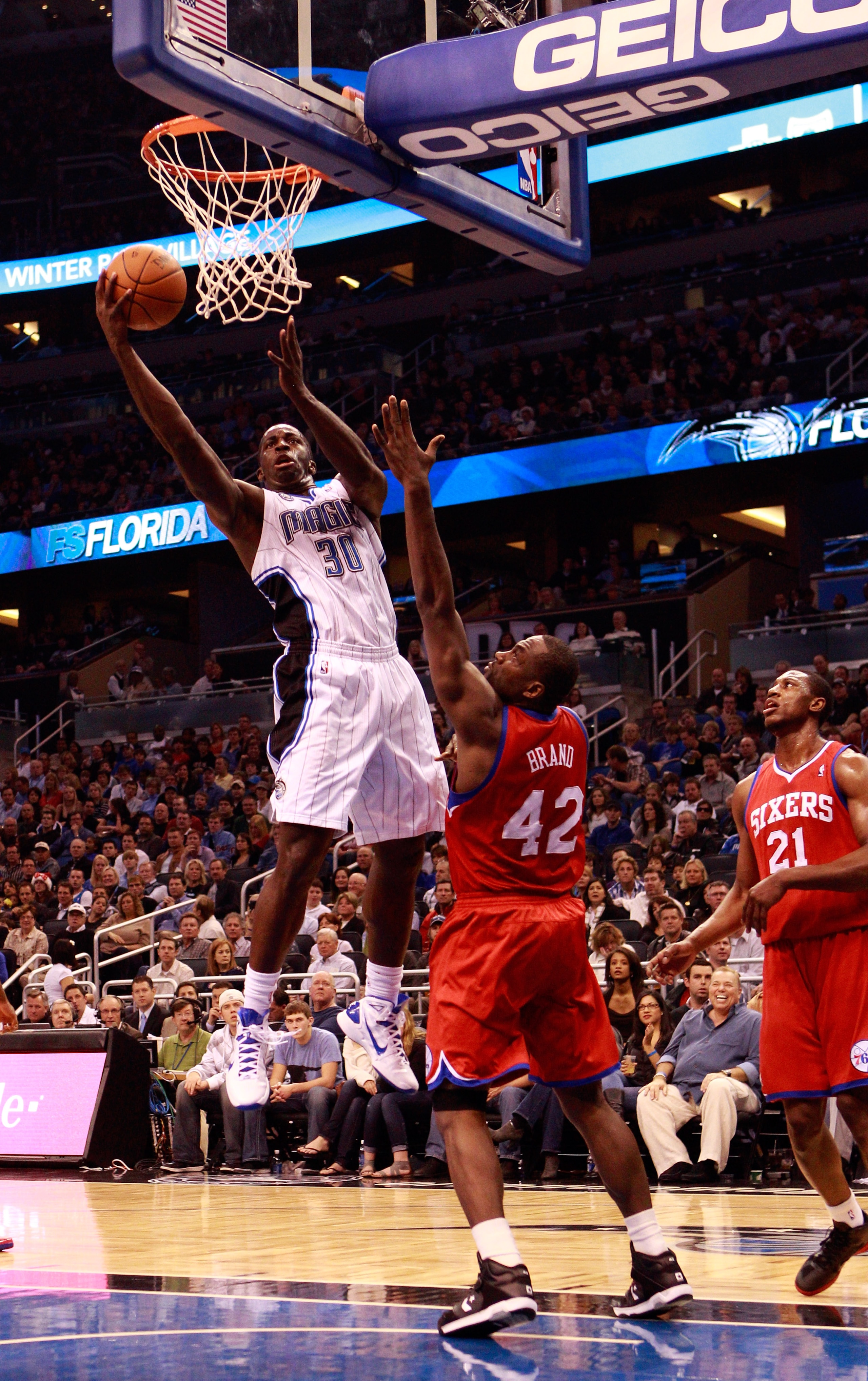 ORLANDO, FL - DECEMBER 18:  Brandon Bass #30 of the Orlando Magic attempts a shot over Elton Brand #42 of the Philadelphia 76ers during the game at Amway Arena on December 18, 2010 in Orlando, Florida.  NOTE TO USER: User expressly acknowledges and agrees