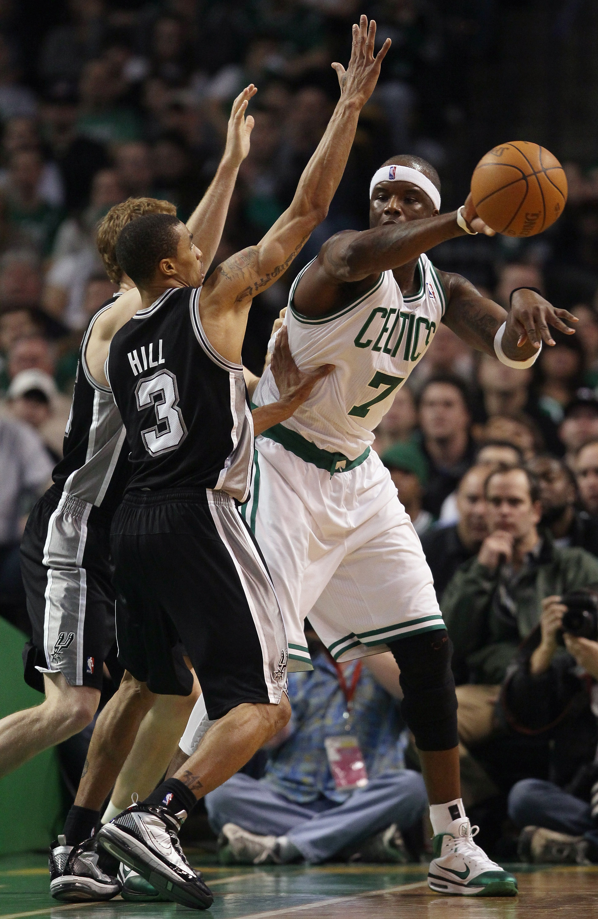 BOSTON, MA - JANUARY 05: Jermaine O'Neal #7 of the Boston Celtics passes the ball around George Hill #3 and Matt Bonner #15 of the San Antonio Spurs on January 5, 2011 at the TD Garden in Boston, Massachusetts. The Celtics defeated the Spurs 105-103. NOT BOSTON, MA - JANUARY 05: Jermaine O'Neal #7 of the Boston Celtics passes the ball around George Hill #3 and Matt Bonner #15 of the San Antonio Spurs on January 5, 2011 at the TD Garden in Boston, Massachusetts. The Celtics defeated the Spurs 105-103. NOT