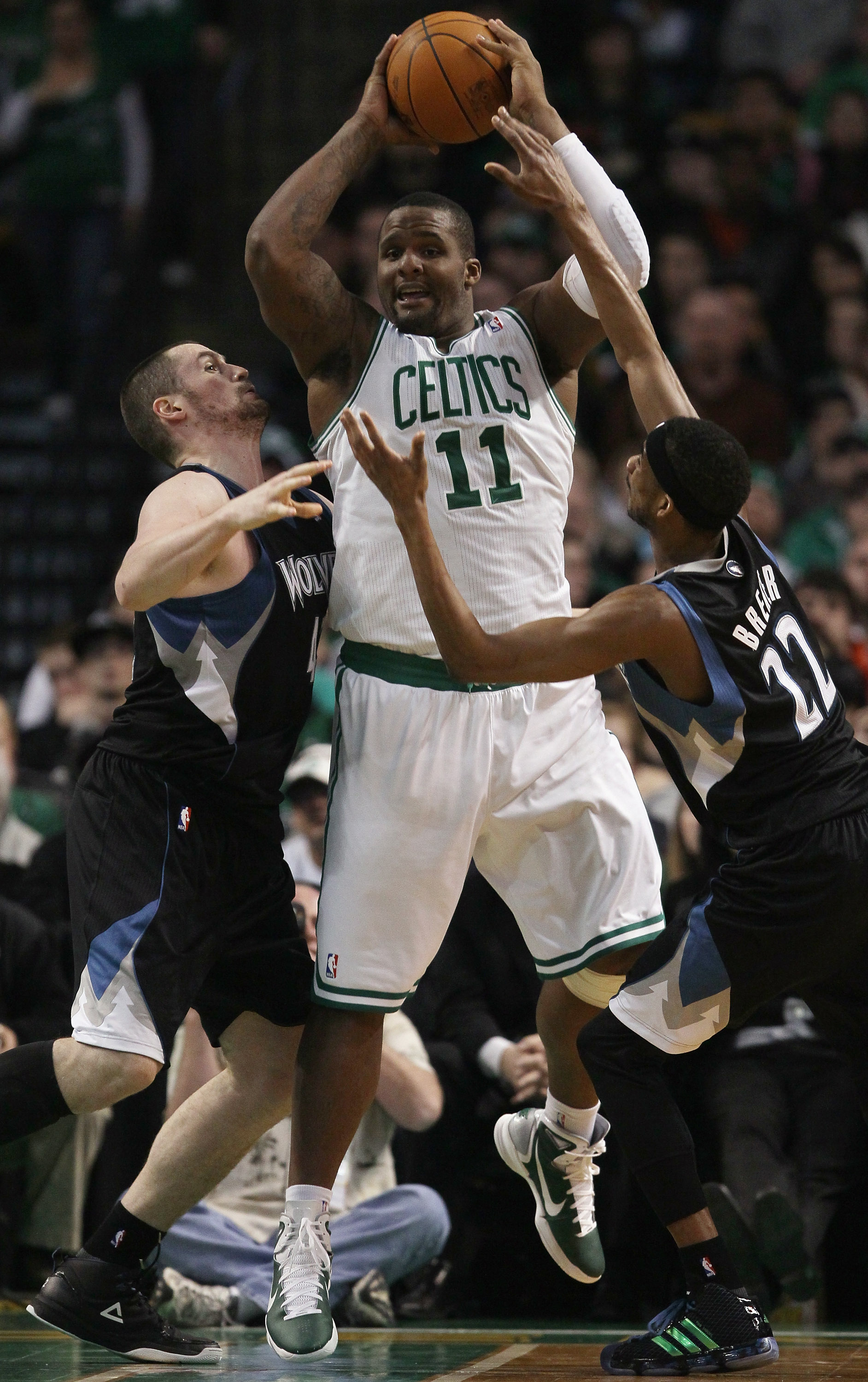 BOSTON, MA - JANUARY 03: Glen Davis #11 of the Boston Celtics looks to pass as Kevin Love #42 and Corey Brewer #22 of the Minnesota Timberwolves defend on January 3, 2011 at the TD Garden in Boston, Massachusetts. The Celtics defeated the Timberwolves 96- BOSTON, MA - JANUARY 03: Glen Davis #11 of the Boston Celtics looks to pass as Kevin Love #42 and Corey Brewer #22 of the Minnesota Timberwolves defend on January 3, 2011 at the TD Garden in Boston, Massachusetts. The Celtics defeated the Timberwolves 96-