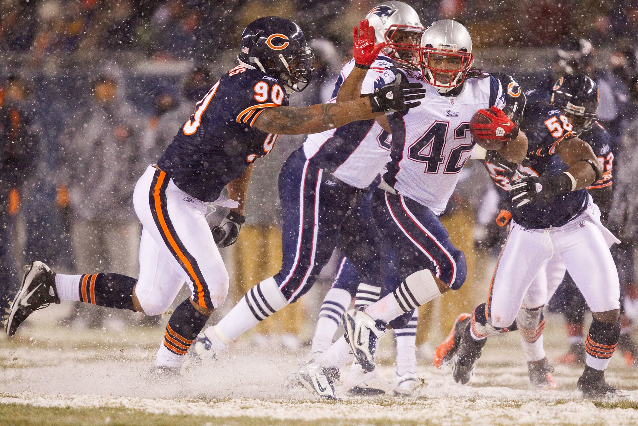 CHICAGO, IL - DECEMBER 12: BenJarvus Green-Ellis #42 of the New England Patriots looks to get past Julius Peppers #90 of the Chicago Bears at Soldier Field on December 12, 2010 in Chicago, Illinois.  The Patriots beat the Bears 36-7.  (Photo by Dilip Vish
