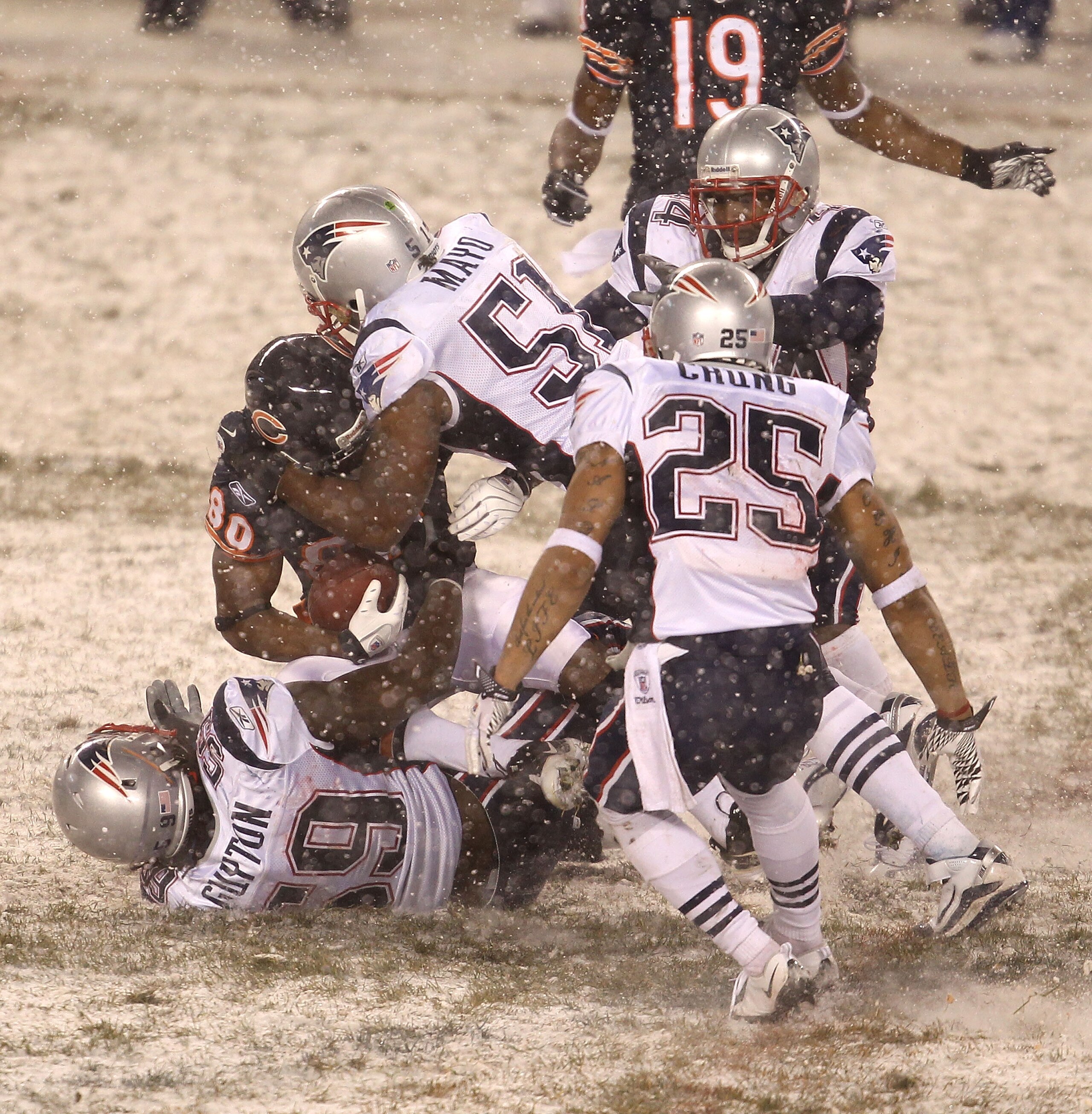 CHICAGO, IL - DECEMBER 12: Earl Bennett #80 of the Chicago Bears is gang-tackled by Gary Guyton #59, Jerod Mayo #51, Patrick Chung #25 and Jarred Page #44 of the New England Patriots at Soldier Field on December 12, 2010 in Chicago, Illinois. The Patriots