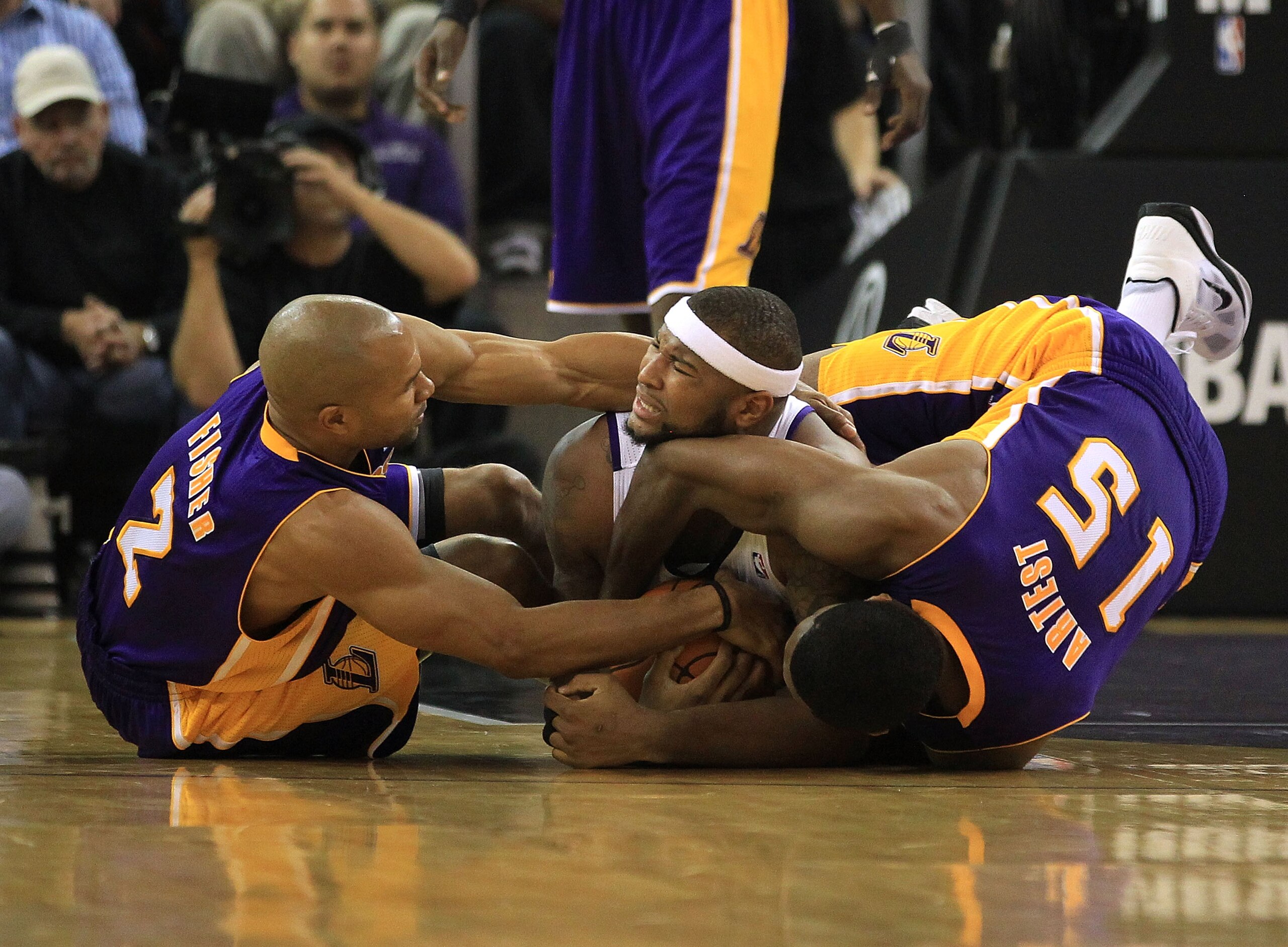 SACRAMENTO, CA - NOVEMBER 03: Derek Fisher #2 and Ron Artest #15 of the Los Angeles Lakers wrestle for the ball with DeMarcus Cousins #15 of the Sacramento Kings at ARCO Arena on November 3, 2010 in Sacramento, California. NOTE TO USER: User expressly a SACRAMENTO, CA - NOVEMBER 03: Derek Fisher #2 and Ron Artest #15 of the Los Angeles Lakers wrestle for the ball with DeMarcus Cousins #15 of the Sacramento Kings at ARCO Arena on November 3, 2010 in Sacramento, California. NOTE TO USER: User expressly a