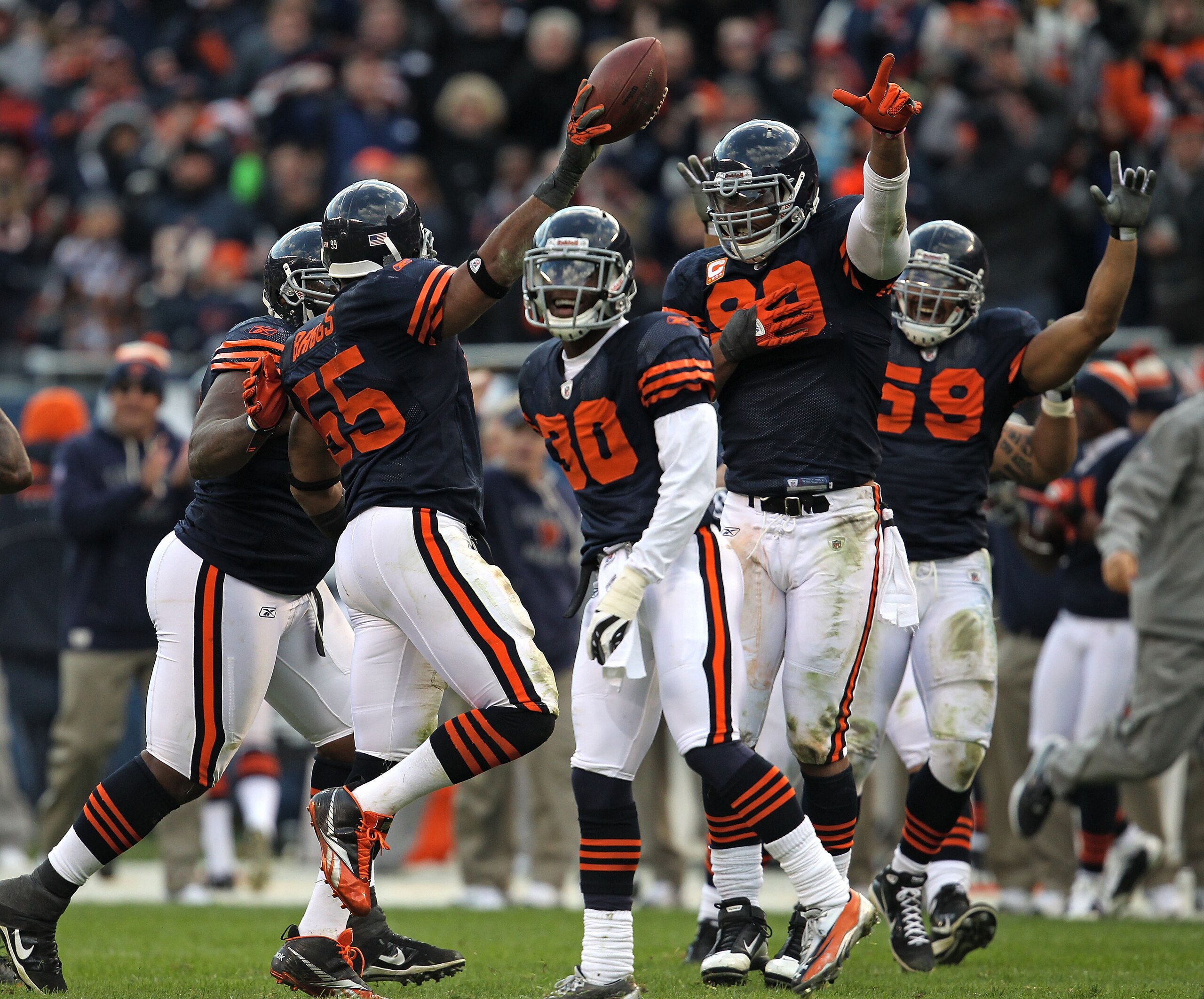 CHICAGO - NOVEMBER 14: Members of the Chicago Bear defense including (L-R) Lance Briggs #55, D.J.Moore #30, Julius Peppers #90 and Pisa Tinoisamoa #59 celebrate Brigg's interception against the Minnesota Vikings at Soldier Field on November 14, 2010 in Ch