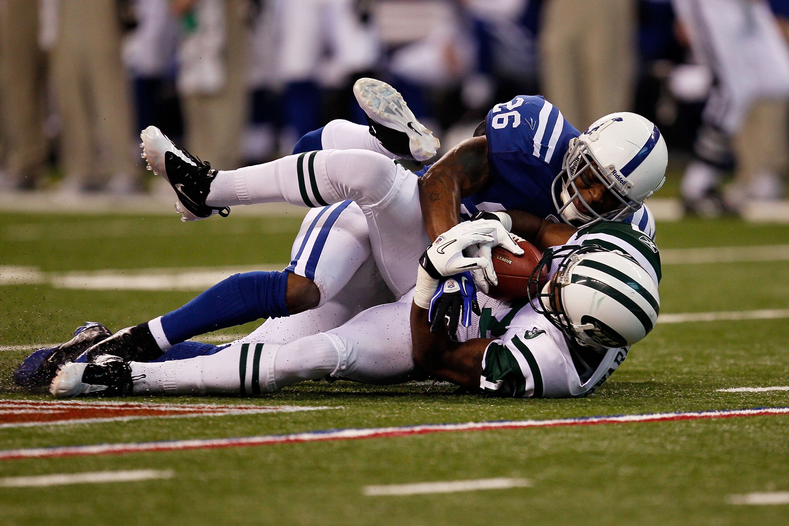 INDIANAPOLIS - JANUARY 24:  Wide receiver Braylon Edwards #17 of the New York Jets is tackled by Kelvin Hayden #26 of the Indianapolis Colts during the AFC Championship Game at Lucas Oil Stadium on January 24, 2010 in Indianapolis, Indiana.  (Photo by Jon