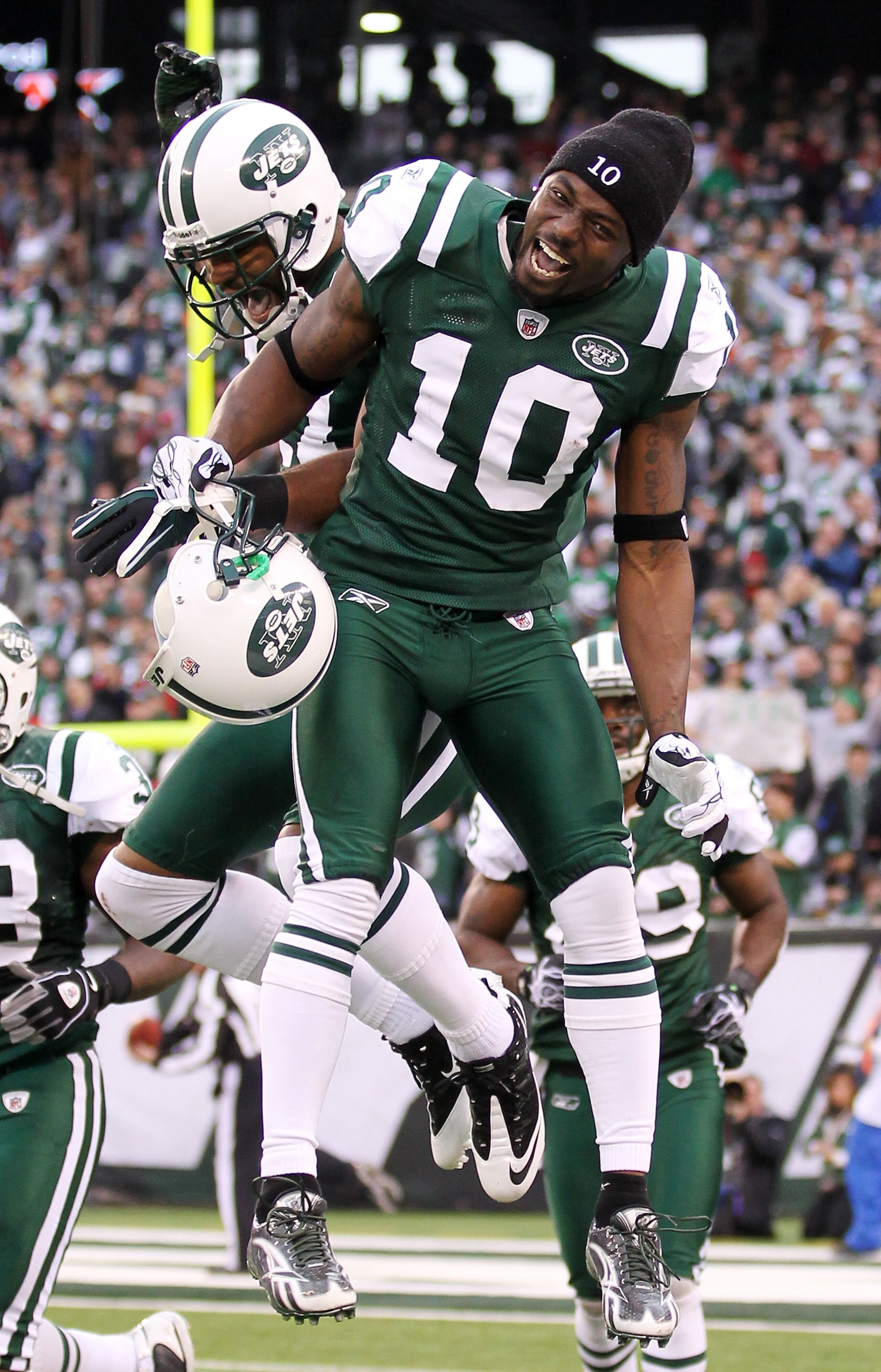 EAST RUTHERFORD, NJ - JANUARY 02:  Braylon Edwards #17 and Santonio Holmes #10 of the New York Jets celebrate Edwards' third quarter touchdown against the Buffalo Bills at New Meadowlands Stadium on January 2, 2011 in East Rutherford, New Jersey.  (Photo 