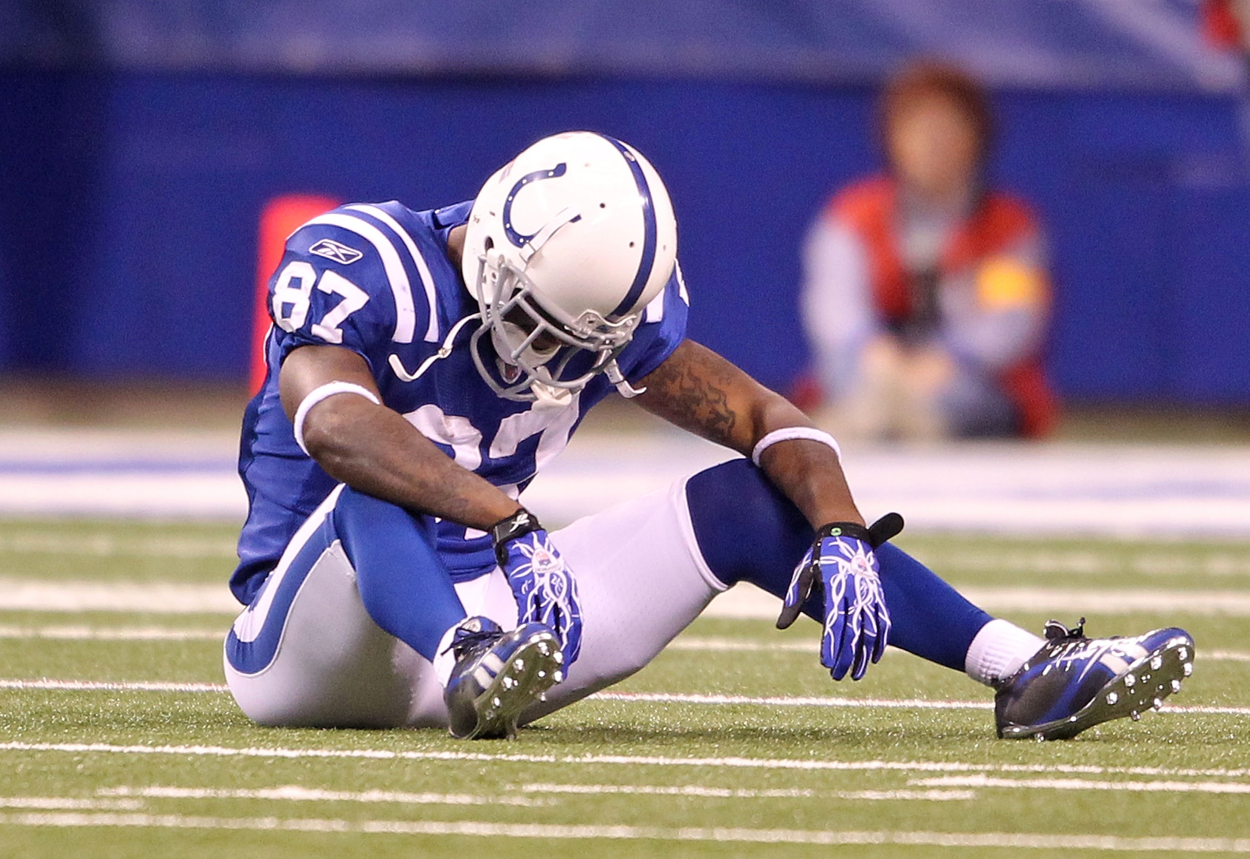 INDIANAPOLIS - NOVEMBER 28:  Reggie Wayne #87 of the Indianapolis Colts sits on the field after dropping a pass during the NFL game against the San Diego Chargers at Lucas Oil Stadium on November 28, 2010 in Indianapolis, Indiana. The chargers won 36-14.