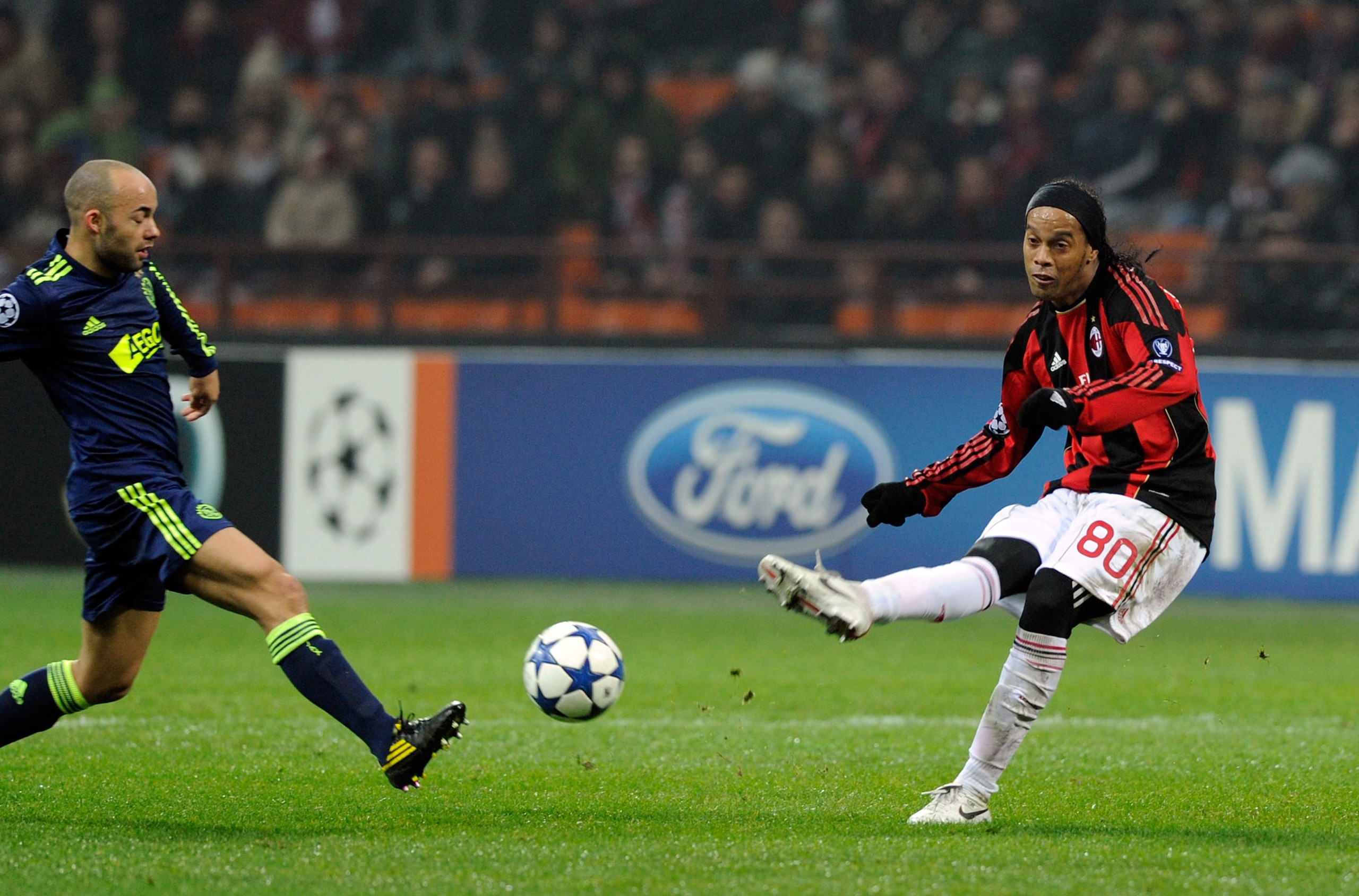 MILAN, ITALY - DECEMBER 08: Ronaldinho of AC Milan and Demy de Zeeuw (L) of AFC Ajax compete for the ball during the UEFA Champions League Group G match between AC Milan and AFC Ajax at Stadio Giuseppe Meazza on December 8, 2010 in Milan, Italy. (Photo MILAN, ITALY - DECEMBER 08: Ronaldinho of AC Milan and Demy de Zeeuw (L) of AFC Ajax compete for the ball during the UEFA Champions League Group G match between AC Milan and AFC Ajax at Stadio Giuseppe Meazza on December 8, 2010 in Milan, Italy. (Photo