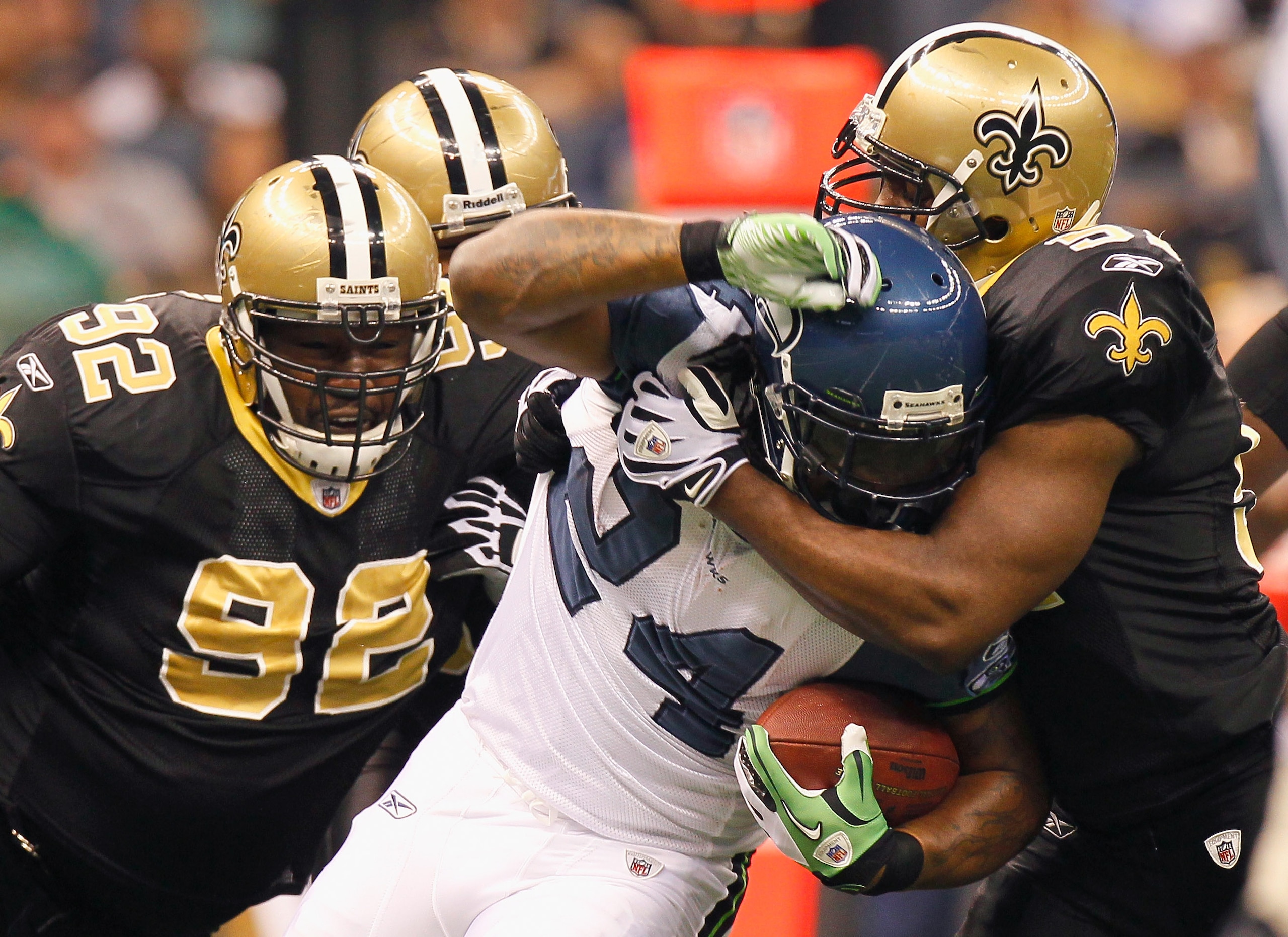 NEW ORLEANS - NOVEMBER 21: Jonathan Vilma #51 and Remi Ayodele #92 of the New Orleans Saints tackle Marshawn Lynch #24 of the Seattle Seahawks at Louisiana Superdome on November 21, 2010 in New Orleans, Louisiana. (Photo by Kevin C. Cox/Getty Images) NEW ORLEANS - NOVEMBER 21: Jonathan Vilma #51 and Remi Ayodele #92 of the New Orleans Saints tackle Marshawn Lynch #24 of the Seattle Seahawks at Louisiana Superdome on November 21, 2010 in New Orleans, Louisiana. (Photo by Kevin C. Cox/Getty Images)