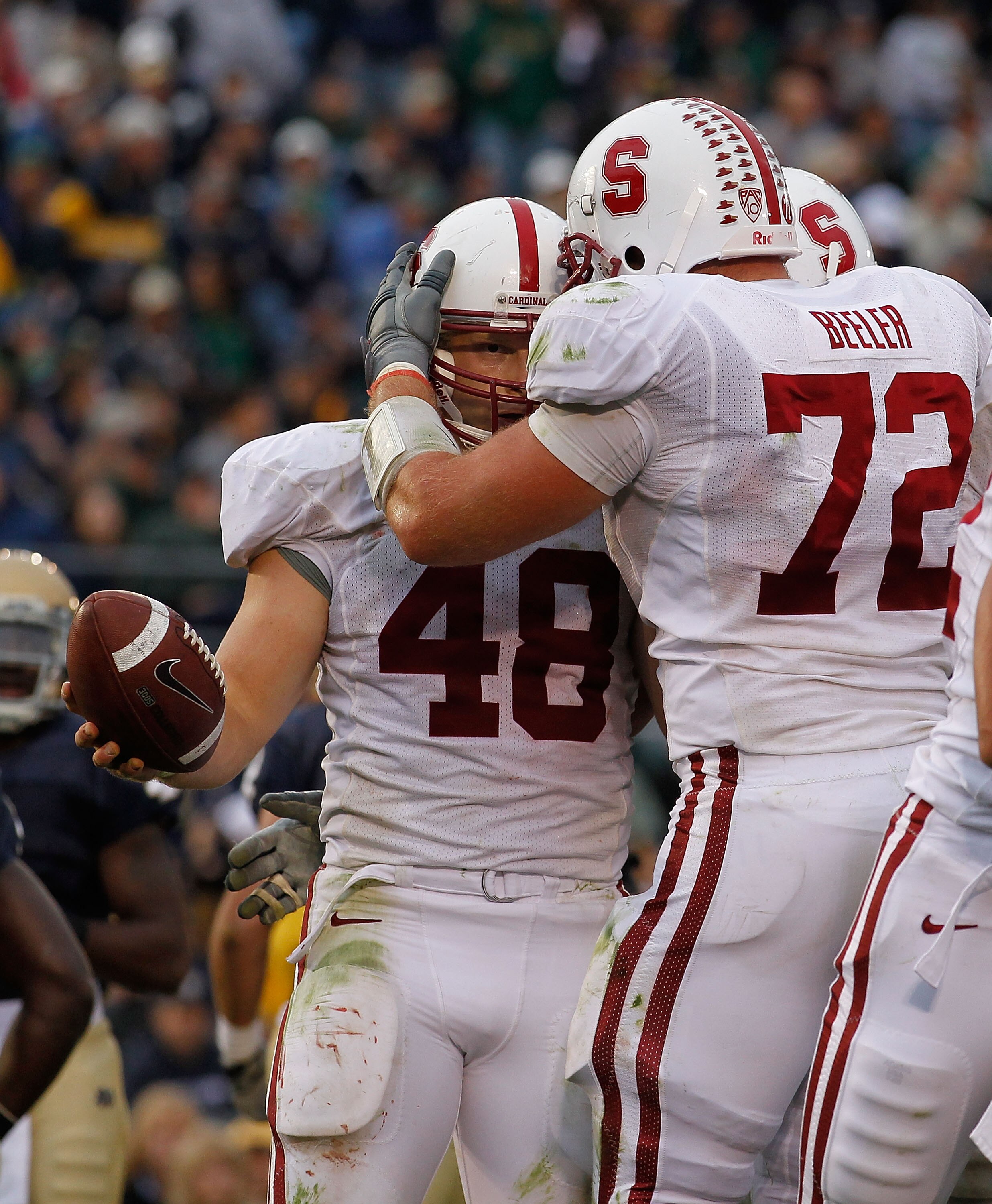 SOUTH BEND, IN - SEPTEMBER 25: Chase Beeler #72 of the Stanford Cardinal congratulates teammate Owen Marecic #48 after Marecic scored an offensive touchdown against the Notre Dame Fighting Irish at Notre Dame Stadium on September 25, 2010 in South Bend, I