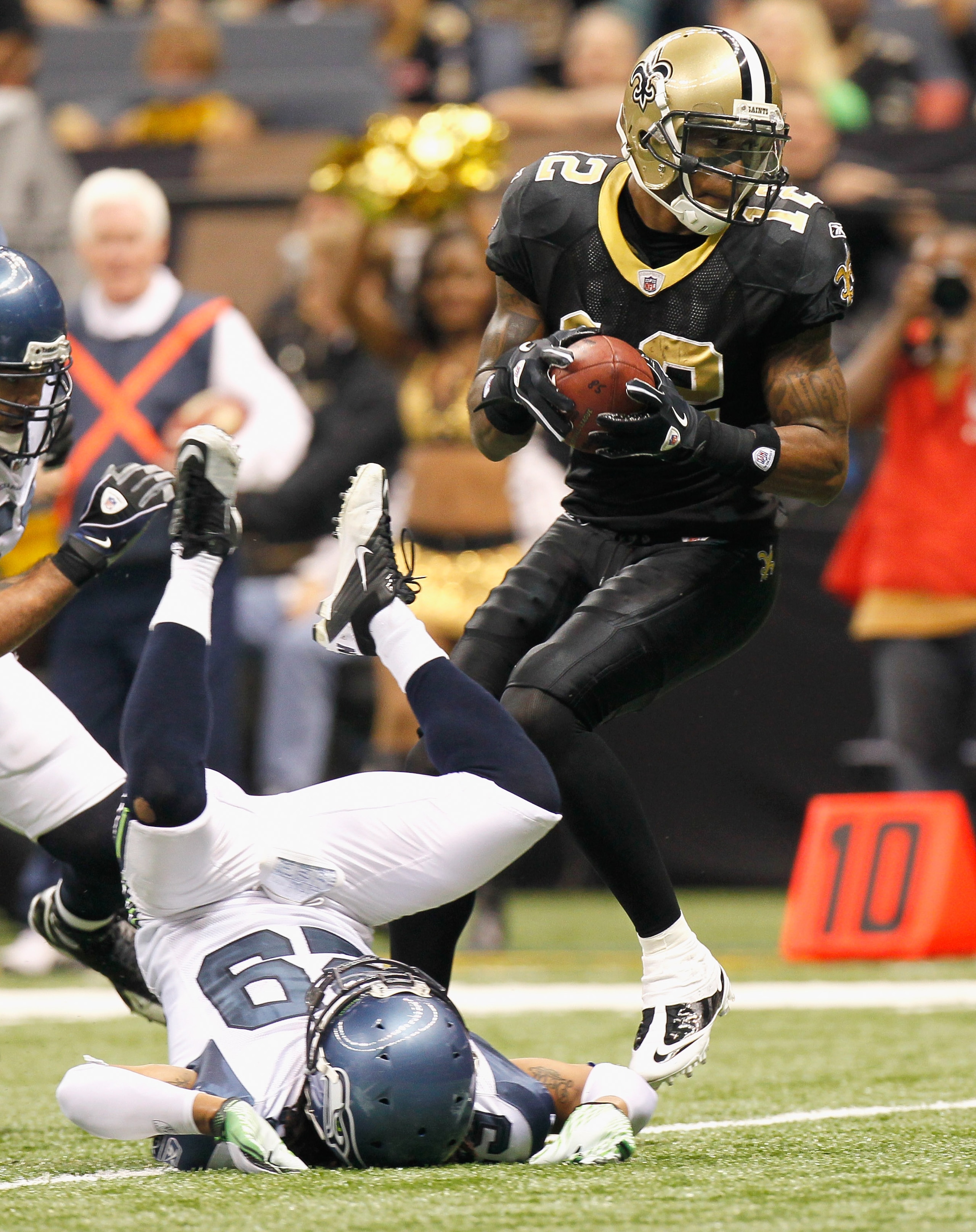 NEW ORLEANS - NOVEMBER 21: Marques Colston #12 of the New Orleans Saints scores a touchdown after running over Earl Thomas #29 of the Seattle Seahawks at Louisiana Superdome on November 21, 2010 in New Orleans, Louisiana. (Photo by Kevin C. Cox/Getty Im NEW ORLEANS - NOVEMBER 21: Marques Colston #12 of the New Orleans Saints scores a touchdown after running over Earl Thomas #29 of the Seattle Seahawks at Louisiana Superdome on November 21, 2010 in New Orleans, Louisiana. (Photo by Kevin C. Cox/Getty Im
