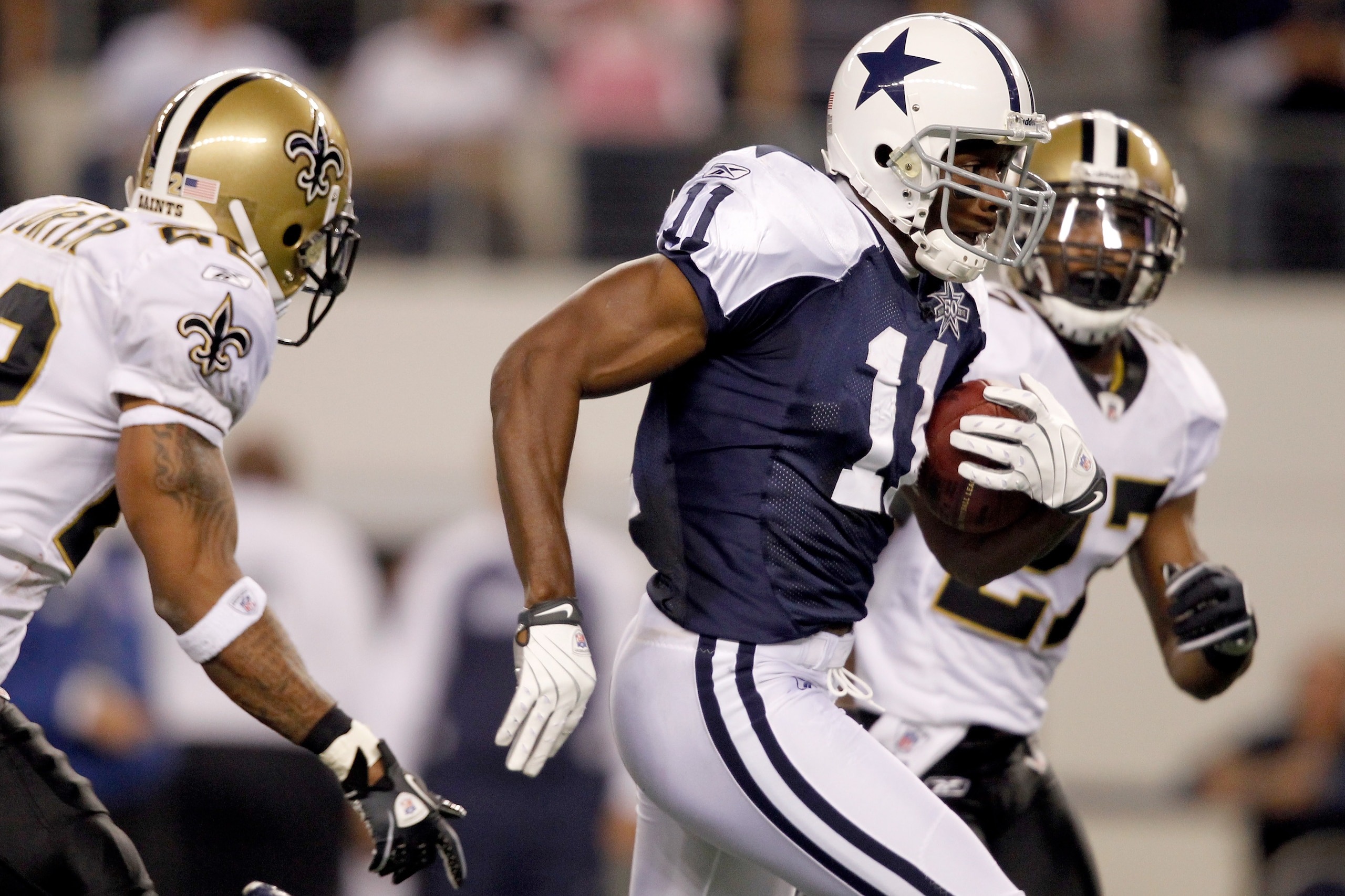 ARLINGTON, TX - NOVEMBER 25: Roy Williams #11 of the Dallas Cowboys carries the ball after making a reception while being pursued by Malcolm Jenkins #27 of the New Orleans Saints at Cowboys Stadium on November 25, 2010 in Arlington, Texas. Jenkins would ARLINGTON, TX - NOVEMBER 25: Roy Williams #11 of the Dallas Cowboys carries the ball after making a reception while being pursued by Malcolm Jenkins #27 of the New Orleans Saints at Cowboys Stadium on November 25, 2010 in Arlington, Texas. Jenkins would