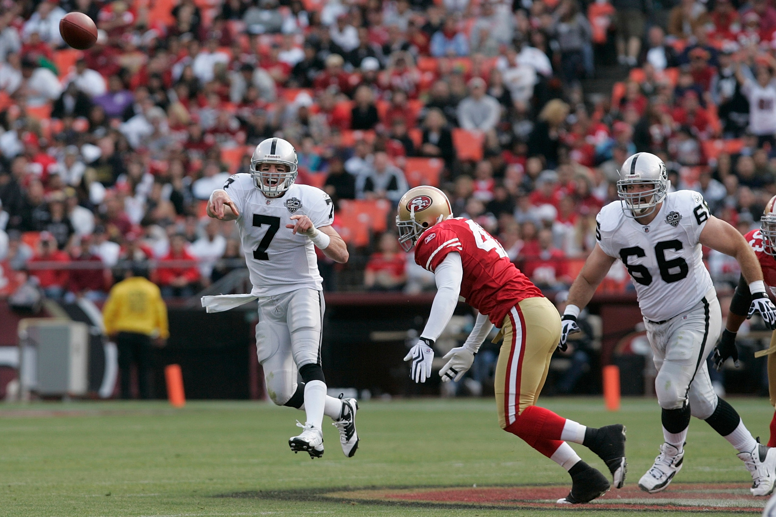 SAN FRANCISCO - AUGUST 22:  Oakland Raiders quarterback Jeff Garcia #7 gets rid of the ball as he is pressured by San Francisco 49ers linebacker Diyral Briggs #47 as Oakland Raiders guard Cooper Carlisle #66 looks on during the 2nd quarter as the San Fran