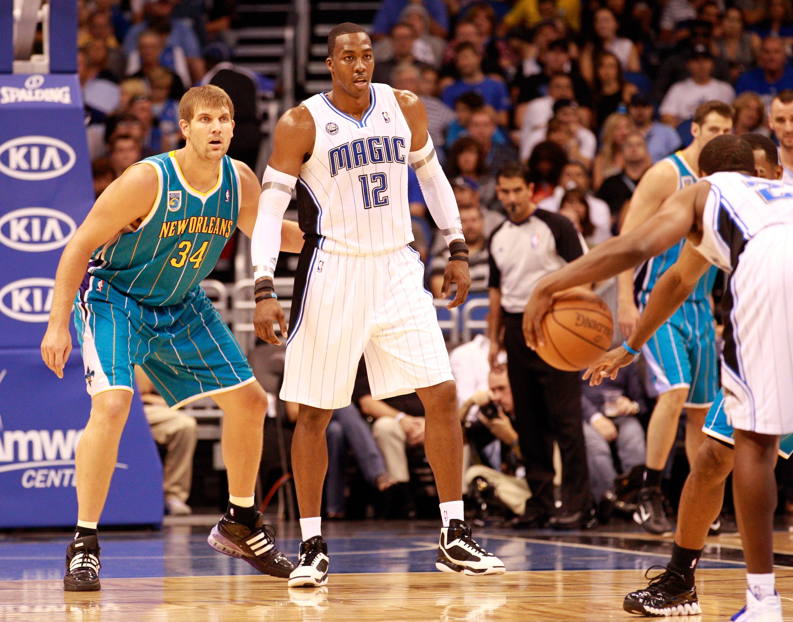 ORLANDO, FL - OCTOBER 10:  Dwight Howard #12 of the Orlando Magic waits to recieve a pass against Aaron Gray #34 of the New Orleans Hornets during the game at Amway Arena on October 10, 2010 in Orlando, Florida. NOTE TO USER: User expressly acknowledges a