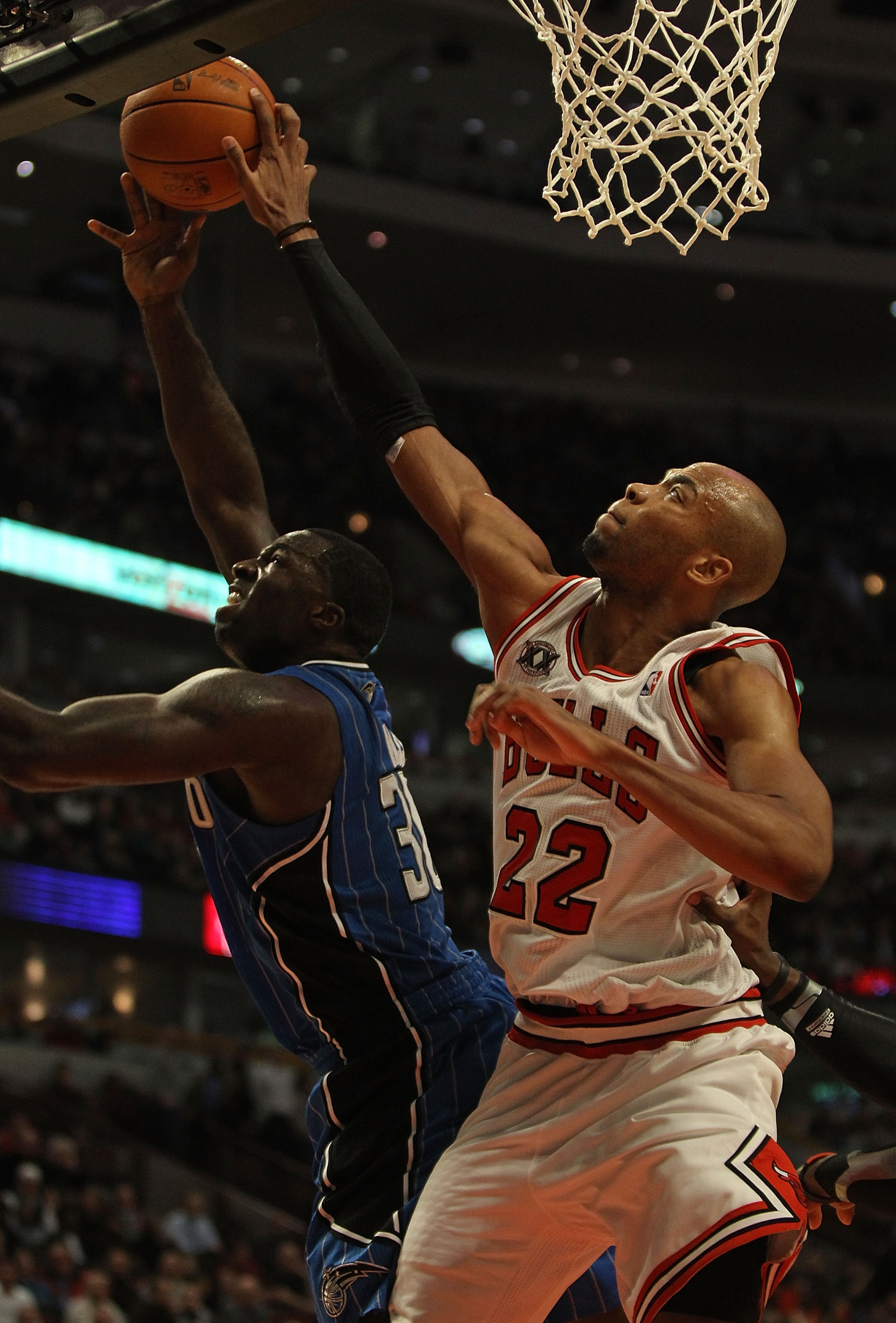 CHICAGO, IL - DECEMBER 01: Taj Gibson #22 of the Chicago Bulls attempts to block a shot by Brandon Bass #30 of the Orlando Magic at the United Center on December 1, 2010 in Chicago, Illinois. The Magic defeated the Bulls 107-78. NOTE TO USER: User express