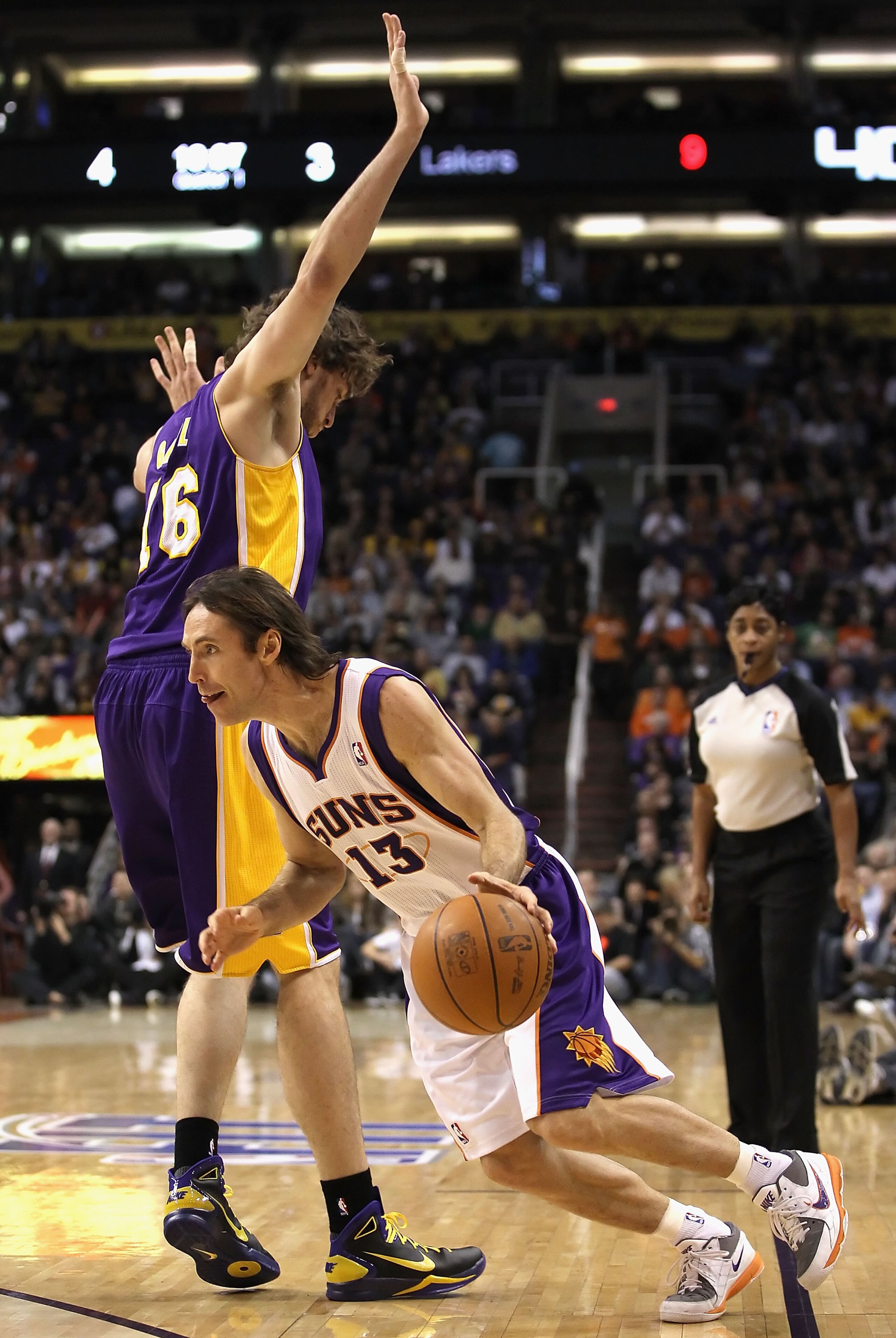 PHOENIX - JANUARY 05: Steve Nash #13 of the Phoenix Suns drives the ball past Pau Gasol #16 of the Los Angeles Lakers during the NBA game at US Airways Center on January 5, 2011 in Phoenix, Arizona. NOTE TO USER: User expressly acknowledges and agrees tha