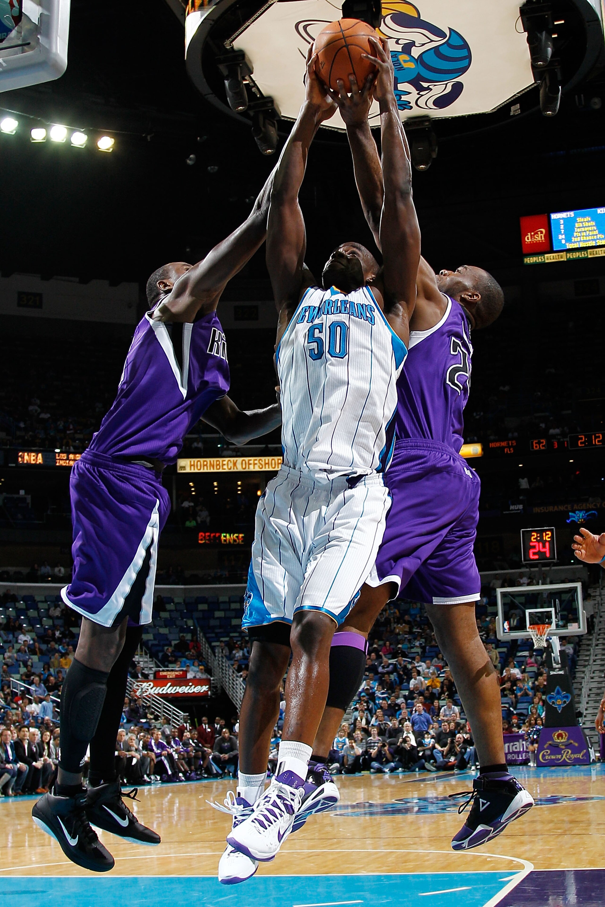 NEW ORLEANS, LA - DECEMBER 15:  Emeka Okafor #50 of the New Orleans Hornets fights for a rebound with Carl Landry #24 of the Sacramento Kings at the New Orleans Arena on December 15, 2010 in New Orleans, Louisiana.  NOTE TO USER: User expressly acknowledg
