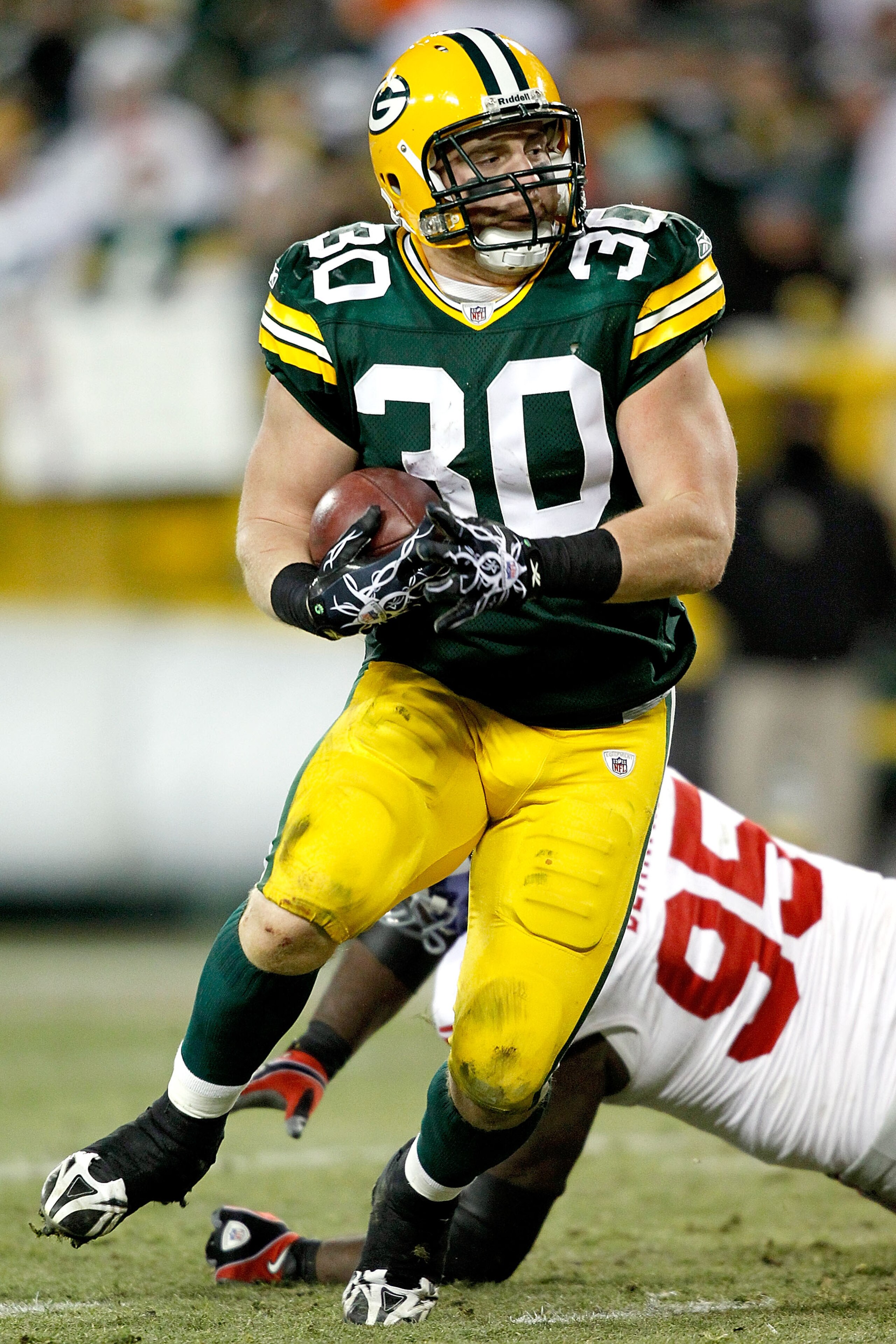 GREEN BAY, WI - DECEMBER 26: John Kuhn #30 of the Green Bay Packers carries the ball for a touchdown against the New York Giants at Lambeau Field on December 26, 2010 in Green Bay, Wisconsin. (Photo by Matthew Stockman/Getty Images) GREEN BAY, WI - DECEMBER 26: John Kuhn #30 of the Green Bay Packers carries the ball for a touchdown against the New York Giants at Lambeau Field on December 26, 2010 in Green Bay, Wisconsin. (Photo by Matthew Stockman/Getty Images)