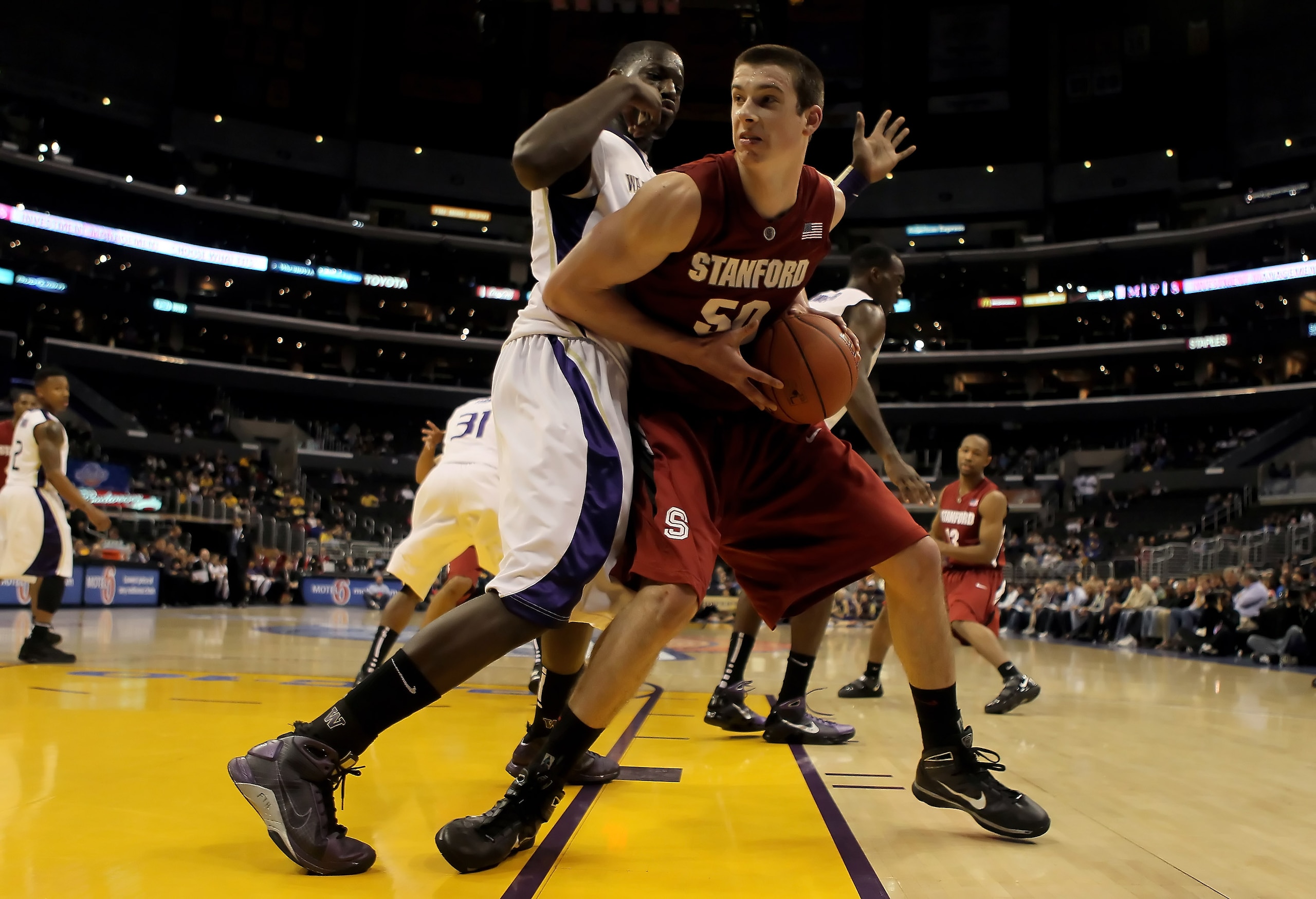 LOS ANGELES, CA - MARCH 12:  Jack Trotter #50 of the Stanford Cardinal is defended by Darnell Gant #44 the Washington Huskies in the second half during the Semifinals of the Pac-10 Basketball Tournament at Staples Center on March 12, 2010 in Los Angeles,