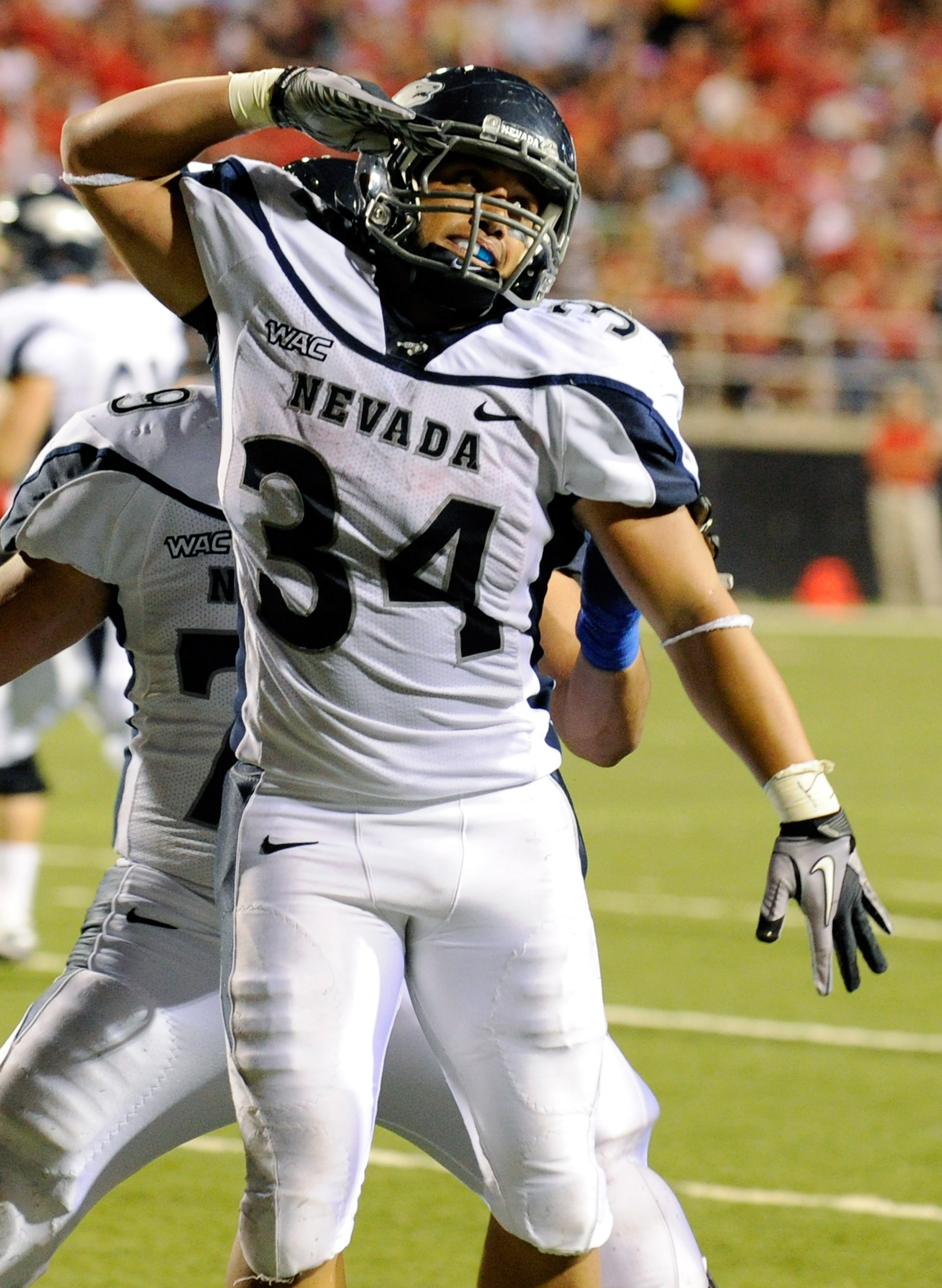 LAS VEGAS - OCTOBER 02: Vai Taua #34 of the Nevada Reno Wolf Pack celebrates after scoring a touchdown against the UNLV Rebels in the second quarter of their game at Sam Boyd Stadium October 2, 2010 in Las Vegas, Nevada. Nevada Reno won 44-26. (Photo by
