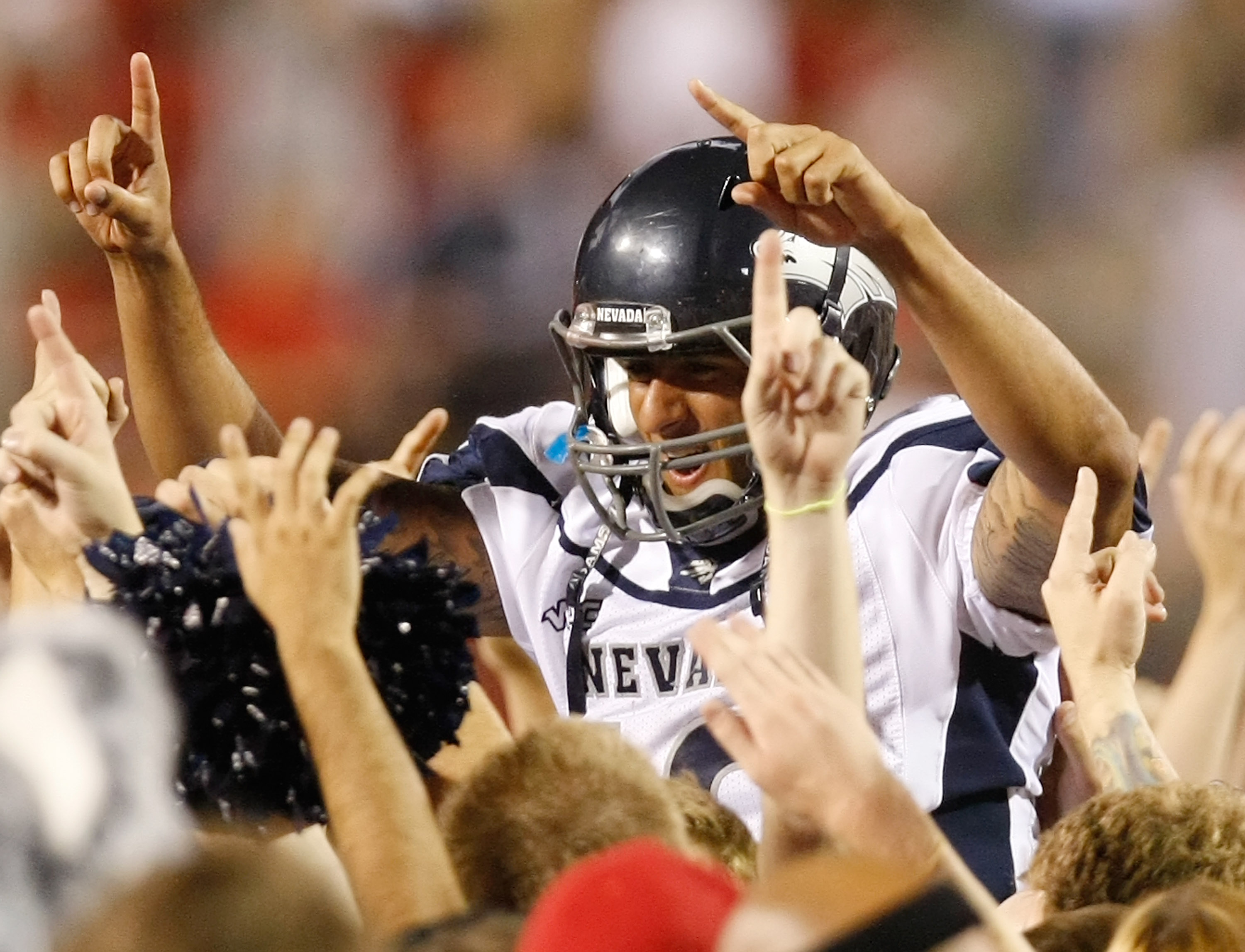 LAS VEGAS - OCTOBER 02: Quarterback Colin Kaepernick #10 of the Nevada Reno Wolf Pack celebrates with fans after defeating the UNLV Rebels 44-26 at Sam Boyd Stadium October 2, 2010 in Las Vegas, Nevada. (Photo by Ethan Miller/Getty Images)