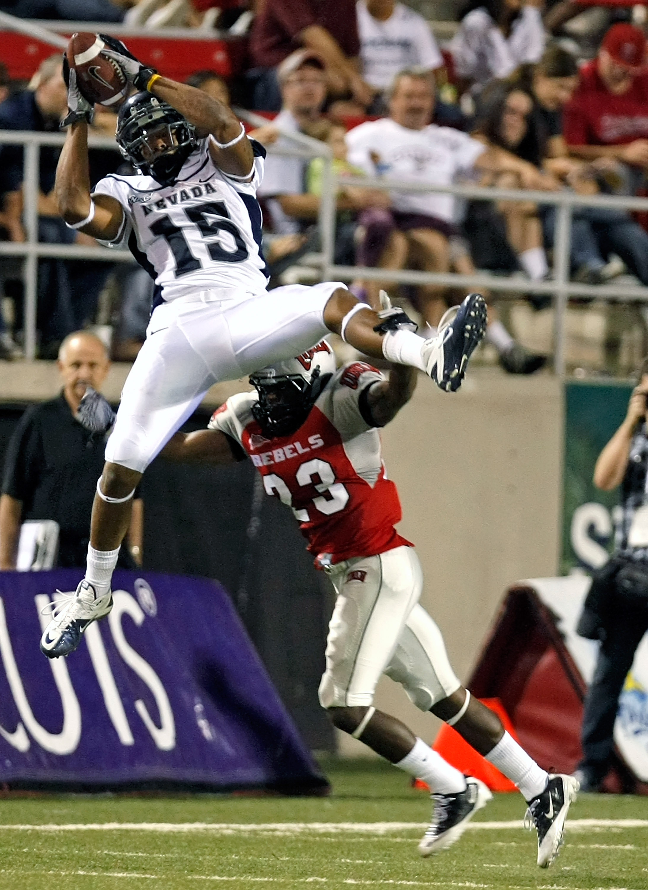 LAS VEGAS - OCTOBER 02: Rishard Matthews #15 of the Nevada Reno Wolf Pack grabs a reception over Sidney Hodge #23 UNLV Rebels during the third quarter of their game at Sam Boyd Stadium October 2, 2010 in Las Vegas, Nevada. Nevada Reno won 44-26. (Photo