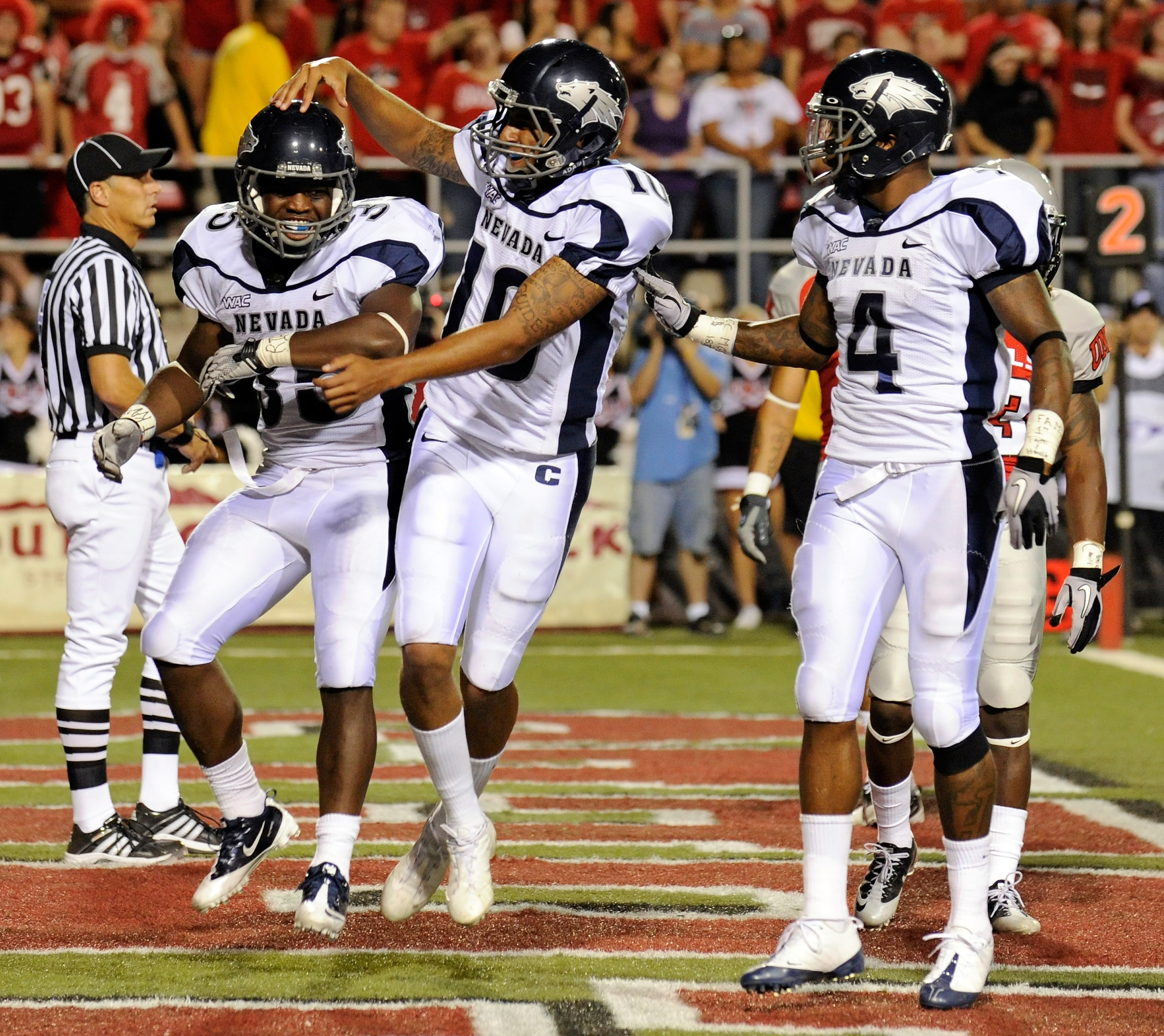 LAS VEGAS - OCTOBER 02: (L-R) Courtney Randall #35 of the Nevada Reno Wolf Pack is congratulated by quarterback Colin Kaepernick #10 and Brandon Wimberly #4 after Randall scored a touchdown against the UNLV Rebels in the second quarter of their game at S