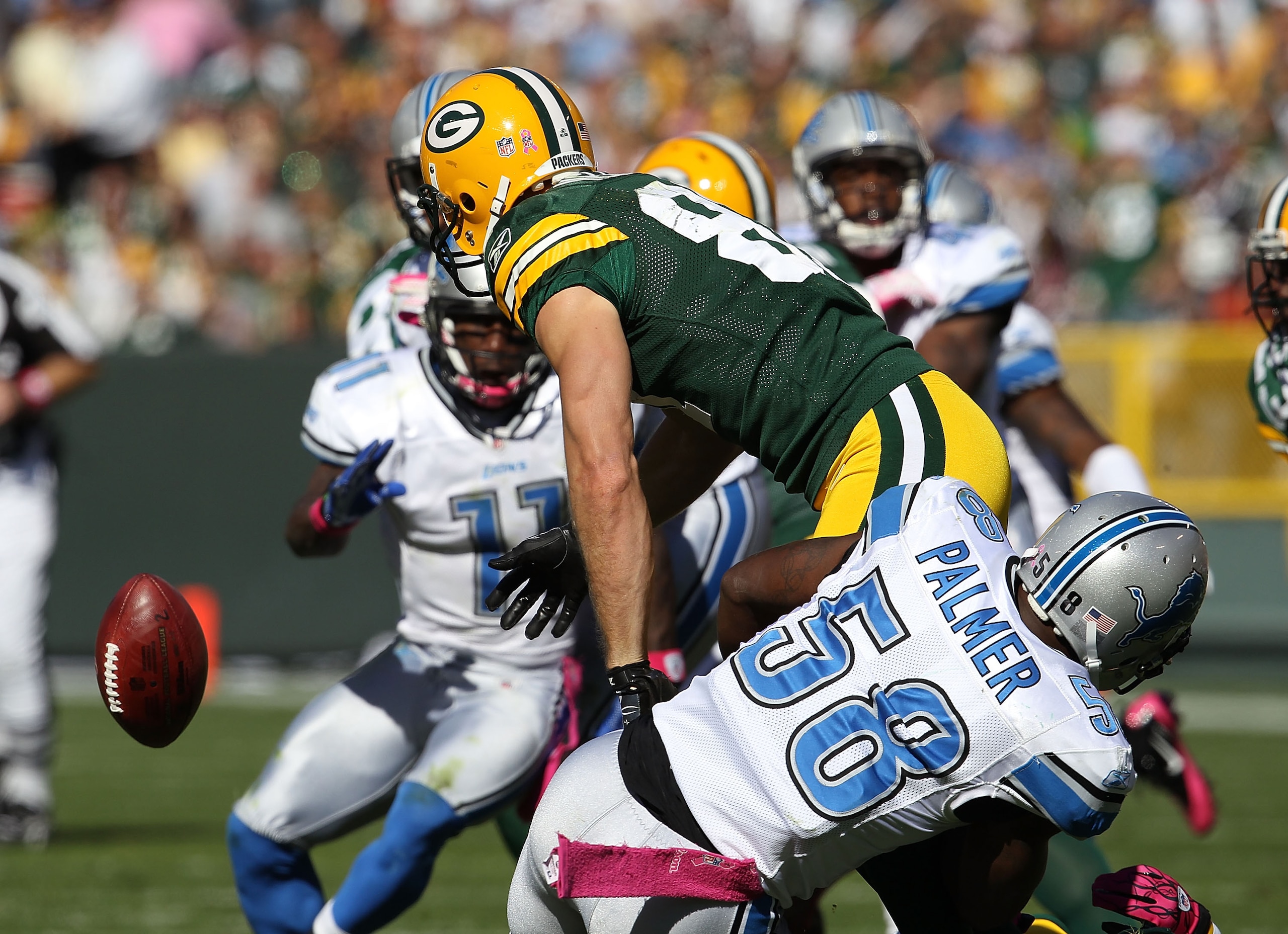 GREEN BAY, WI - OCTOBER 03: Jordy Nelson #87 of the Green Bay Packers fumbles the ball on a kick return as he is hit by Ashlee Palmer #58 of the Detroit Lions at Lambeau Field on October 3, 2010 in Green Bay, Wisconsin. The Packers defeated the Lions 28-2