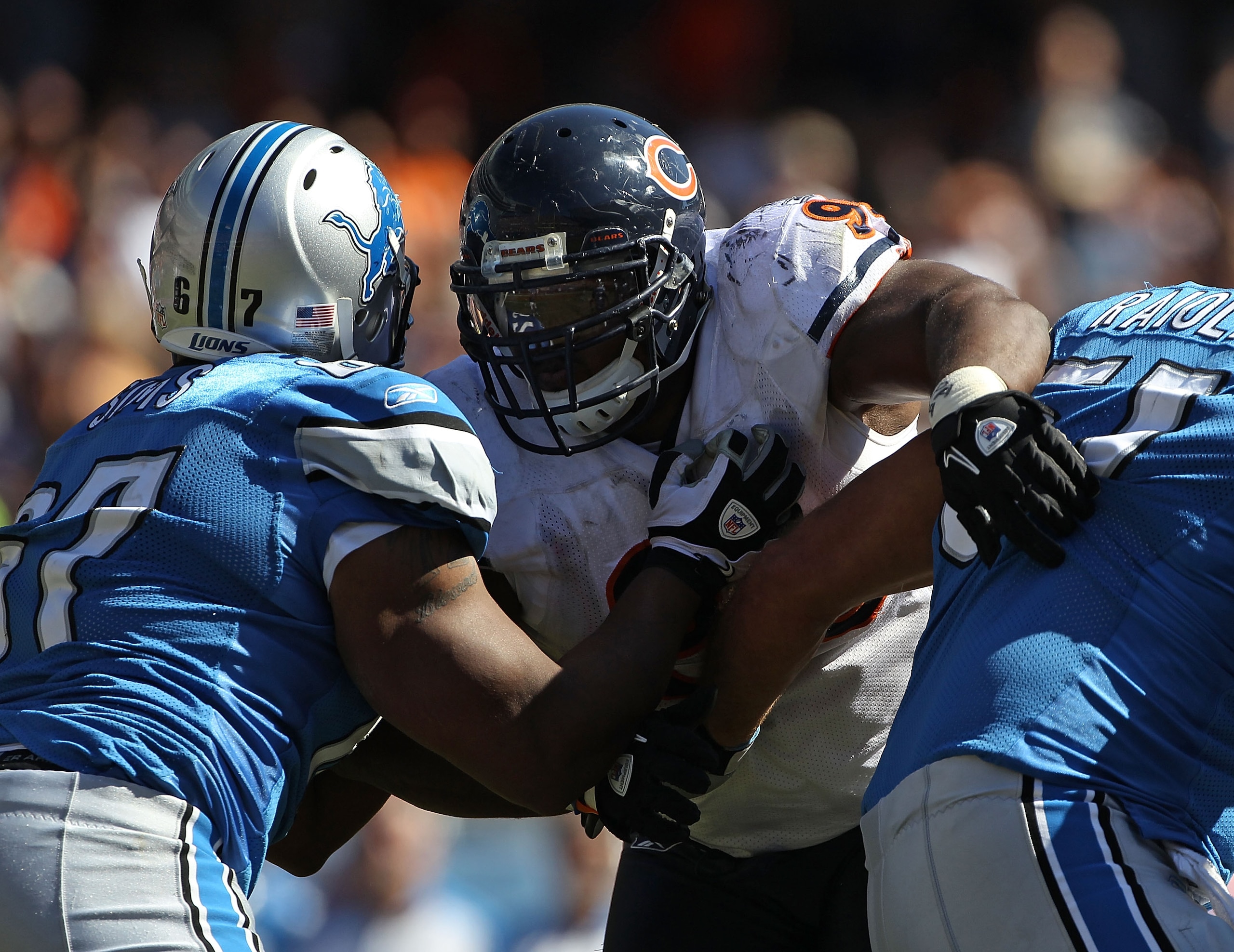CHICAGO - SEPTEMBER 12: Anthony Adams #95 of the Chicago Bears rushes against Rob Sims #67 and Dominic Raiola #51 of the Detroit Lions during the NFL season opening game at Soldier Field on September 12, 2010 in Chicago, Illinois. The Bears defeated the L