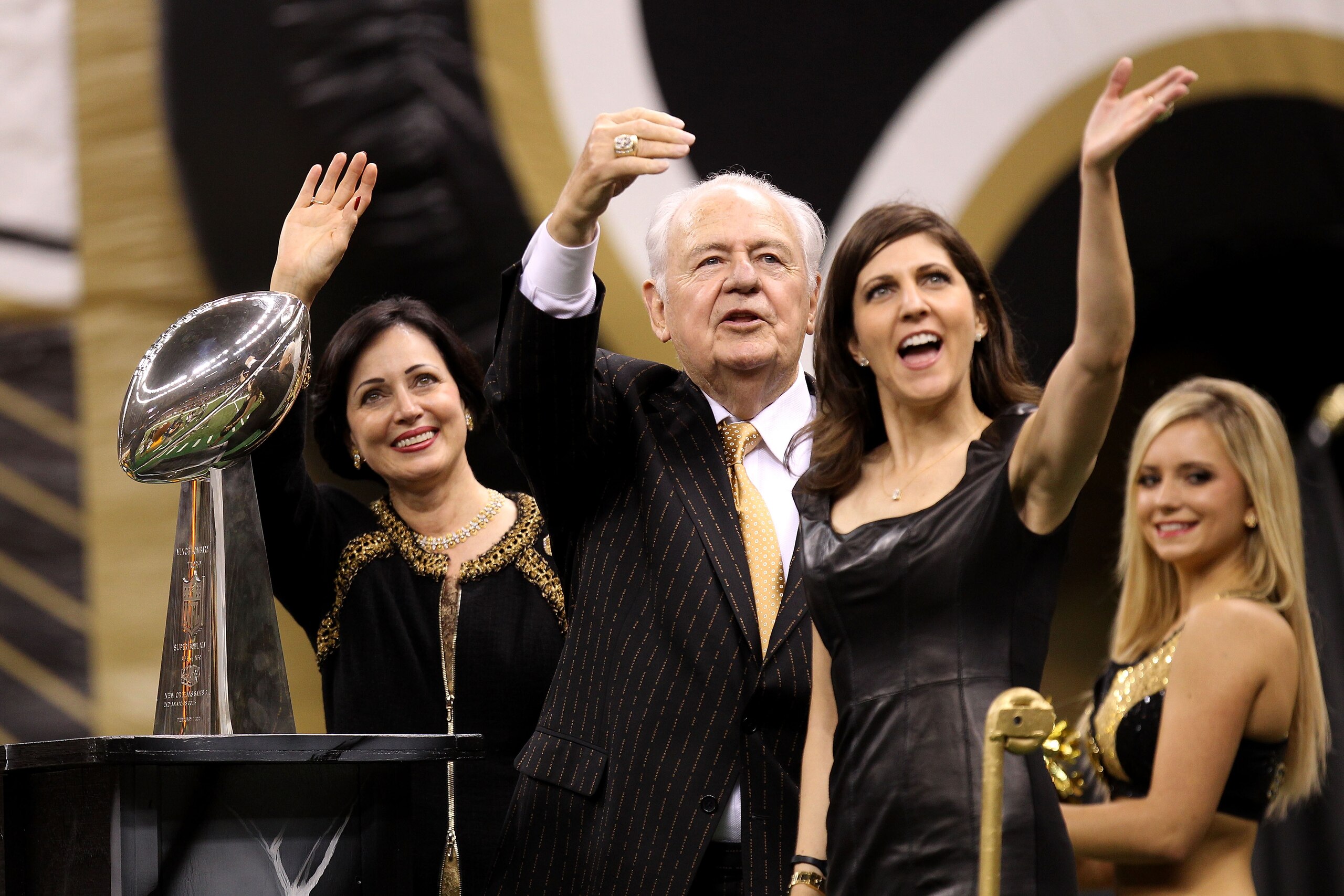 NEW ORLEANS - SEPTEMBER 09:  Team Owner of the New Orleans Saints Tom Benson, his wife Gayle and his daughter Rita Benson Leblanc wave to the fans as they ride a float, displaying the VInce Lombardi trophy, out onto the field prior to the Saints playing a