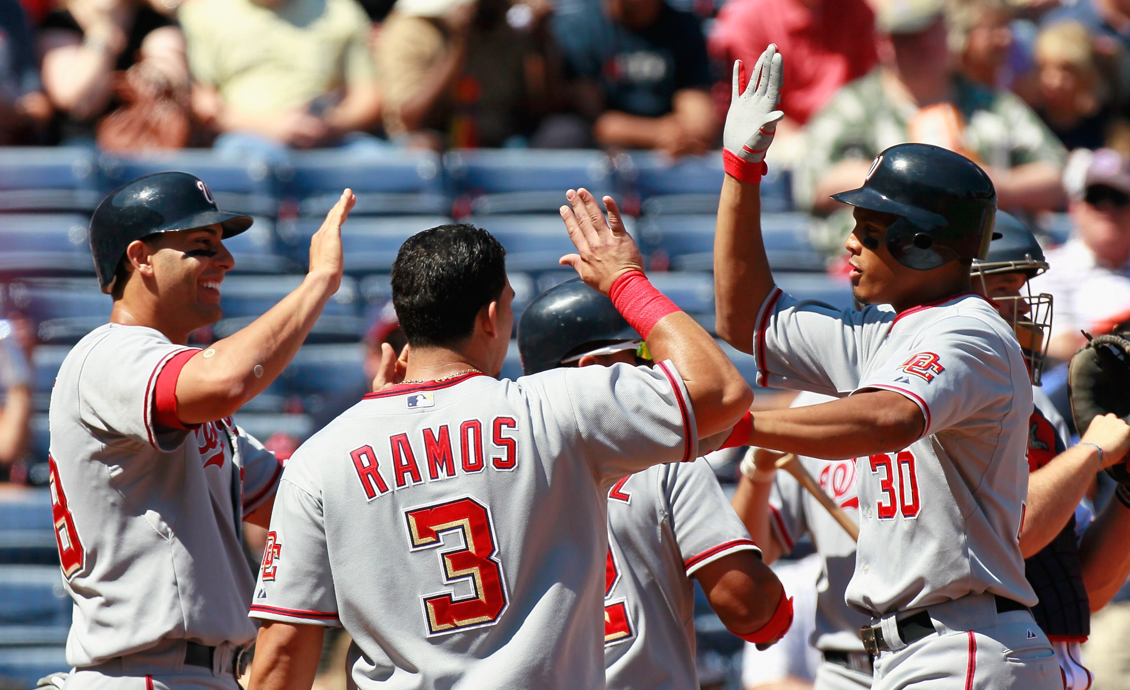 ATLANTA - SEPTEMBER 15:  Justin Maxwell #30 of the Washington Nationals celebrates his grand slam in the second inning against the Atlanta Braves with Mike Morse #28 and Wilson Ramos #3 at Turner Field on September 15, 2010 in Atlanta, Georgia.  (Photo by