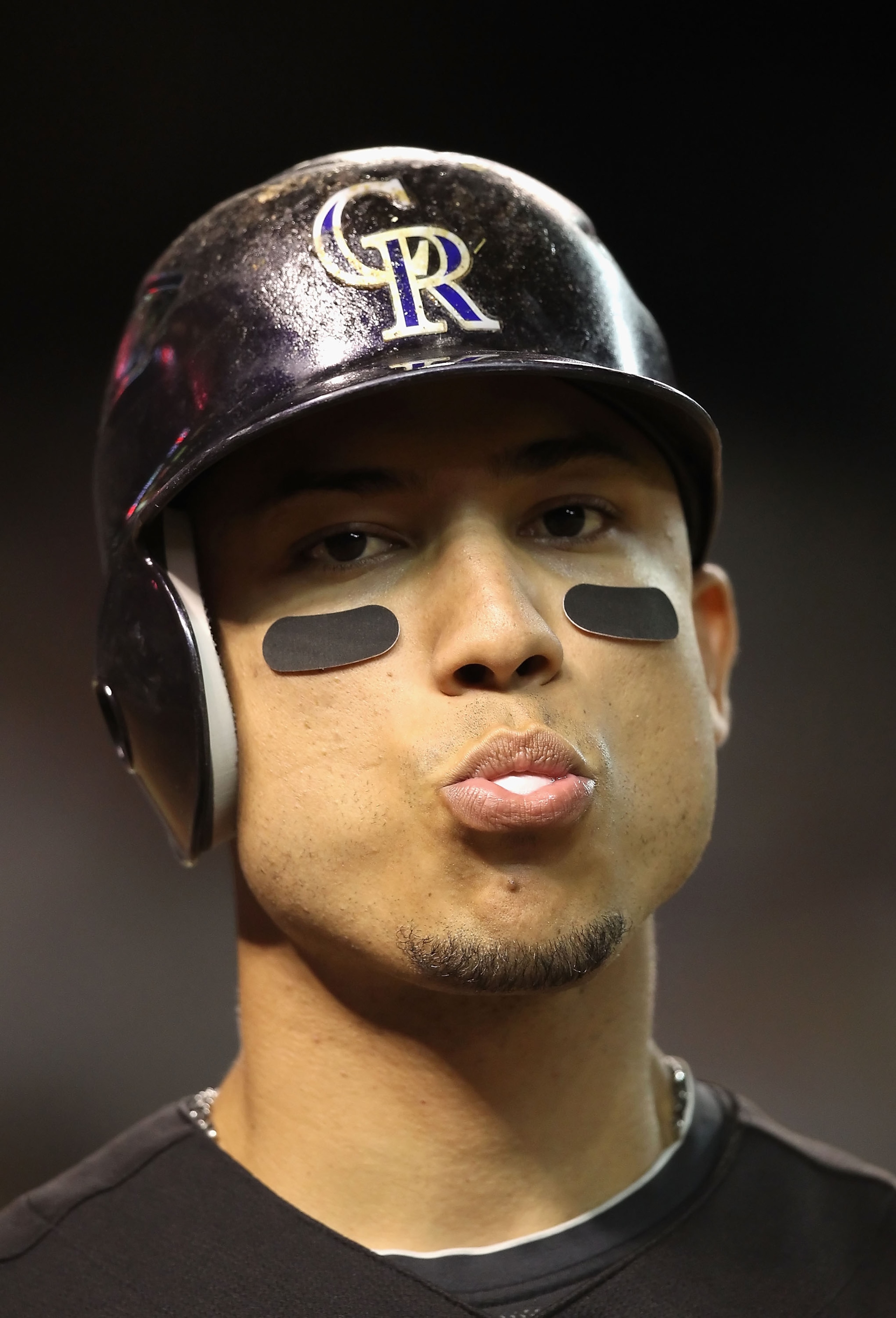 PHOENIX - SEPTEMBER 22:  Carlos Gonzalez #5 of the Colorado Rockies warms up on deck during the Major League Baseball game against the Arizona Diamondbacks at Chase Field on September 22, 2010 in Phoenix, Arizona.  (Photo by Christian Petersen/Getty Image