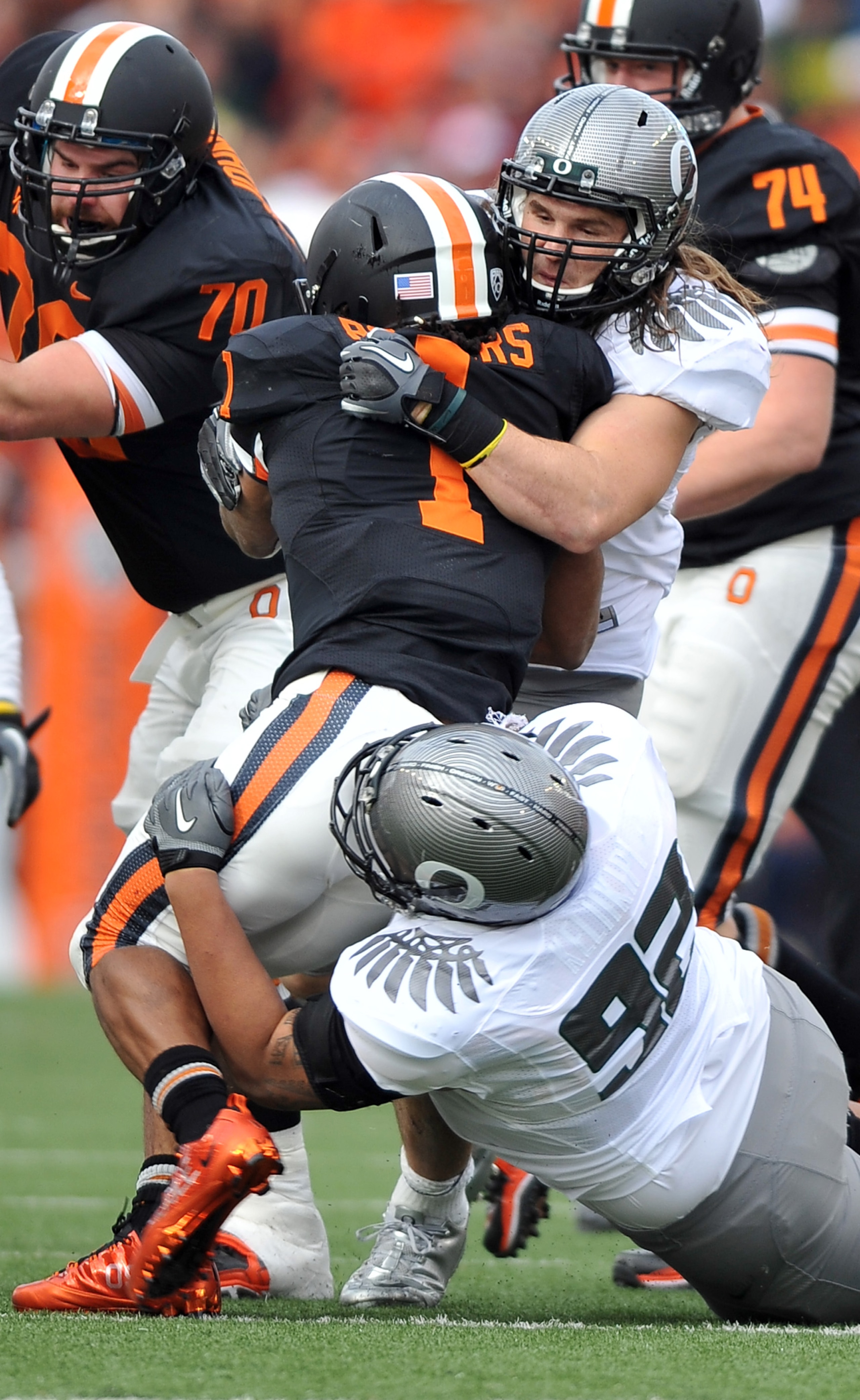 CORVALLIS, OR - DECEMBER 4: Jacquizz Rodgers #1 of the Oregon State Beavers is wrapped up by Casey Matthews #55 and Wade Keliikipi #92 of the Oregon Ducks in the first quarter of the game at Reser Stadium on December 4, 2010 in Corvallis, Oregon. (Photo b CORVALLIS, OR - DECEMBER 4: Jacquizz Rodgers #1 of the Oregon State Beavers is wrapped up by Casey Matthews #55 and Wade Keliikipi #92 of the Oregon Ducks in the first quarter of the game at Reser Stadium on December 4, 2010 in Corvallis, Oregon. (Photo b