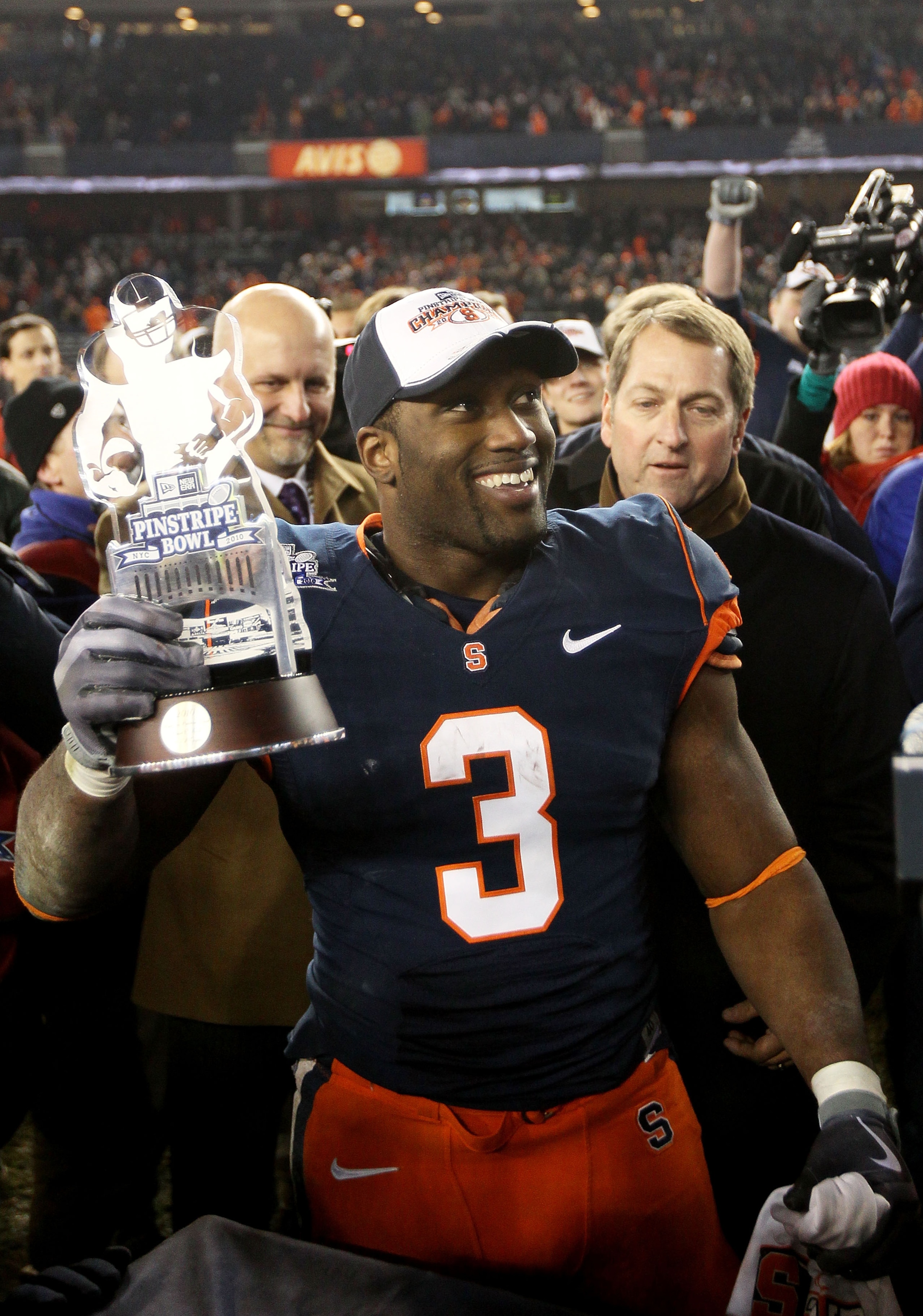 NEW YORK, NY - DECEMBER 30: Delone Carter #3 of the Syracuse Orange celebrates winning the MVP trophy after defeating the Kansas State Wildcats during the New Era Pinstripe Bowl at Yankee Stadium on December 30, 2010 in New York, New York.  (Photo by Chri
