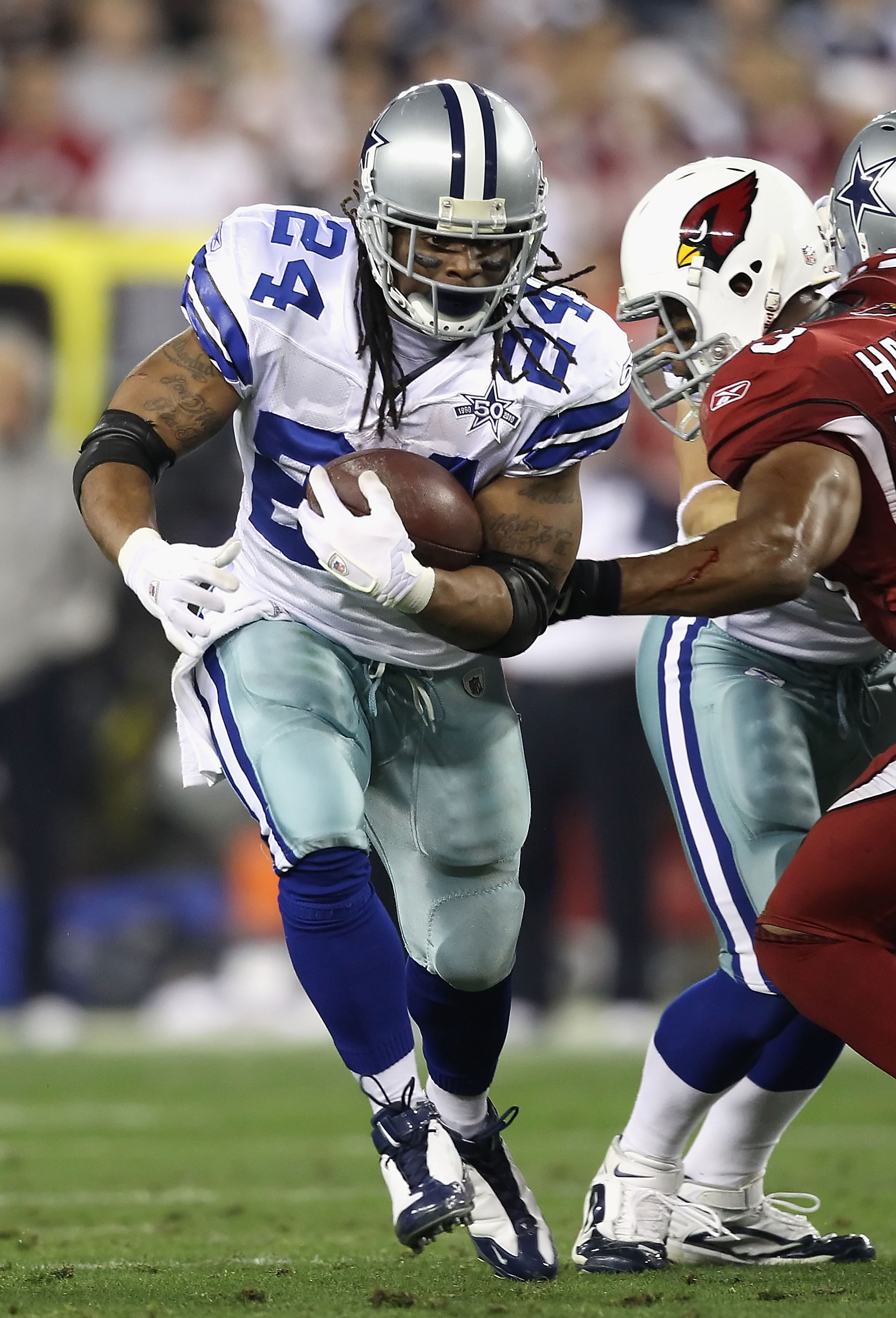 GLENDALE, AZ - DECEMBER 25: Runningback Marion Barber #24 of the Dallas Cowboys rushes the football during the NFL game against the Arizona Cardinals at the University of Phoenix Stadium on December 25, 2010 in Glendale, Arizona. The Cardinals defeated