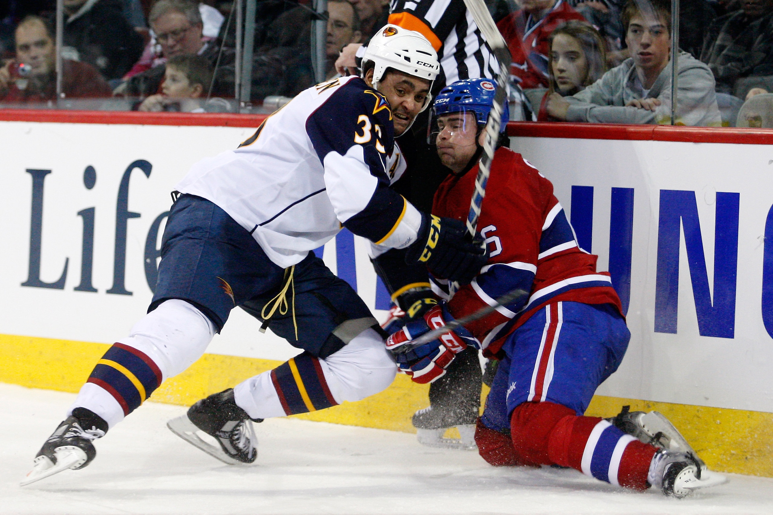MONTREAL, CANADA - JANUARY 2:  Dustin Byfuglien #33 of the Atlanta Thrashers body checks Jaroslav Spacek #6 of the Montreal Canadiens during the NHL game at the Bell Centre on January 2, 2011 in Montreal, Quebec, Canada.  The Thrashers defeated the Canadi