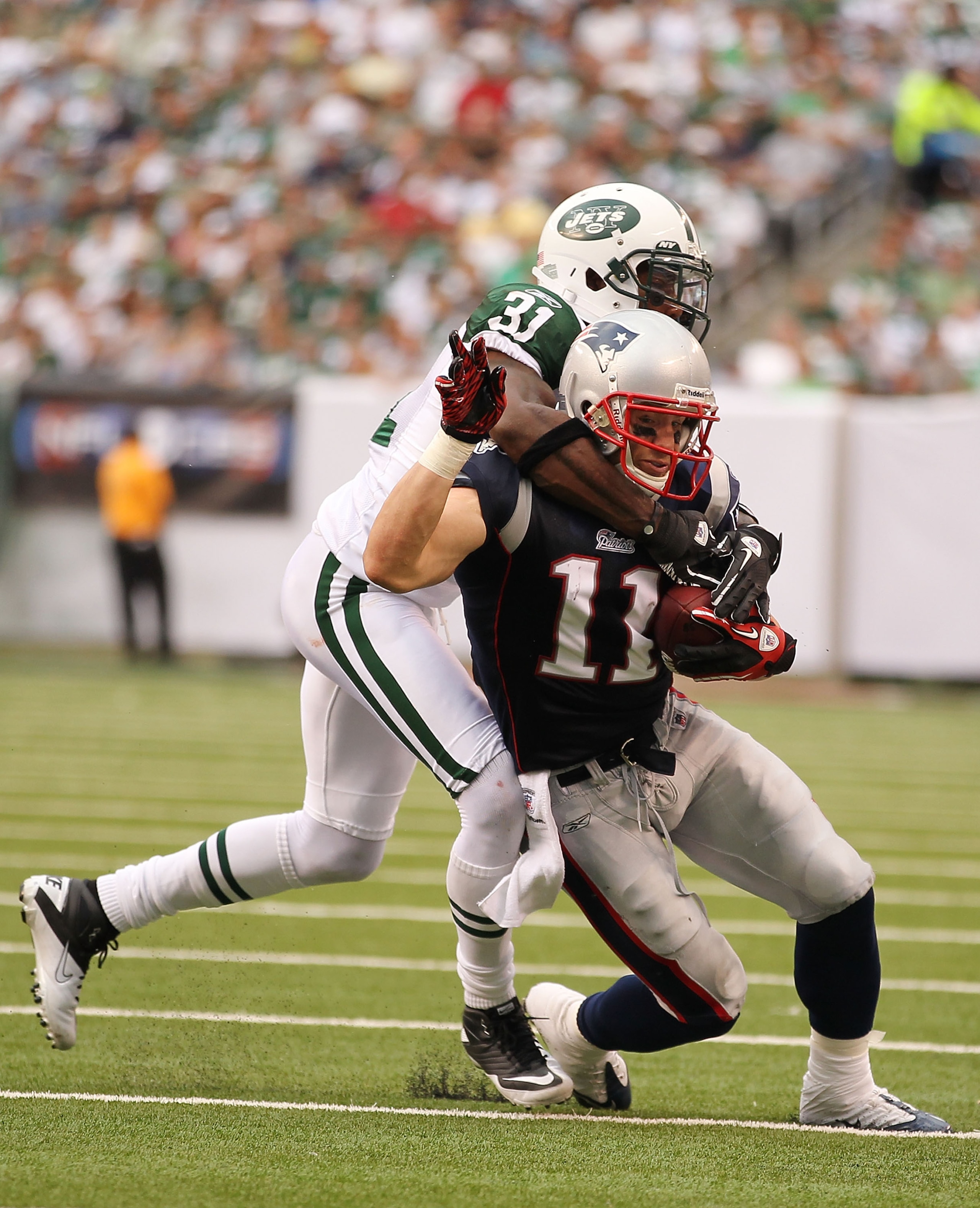 EAST RUTHERFORD, NJ - SEPTEMBER 19: Antonio Cromartie #31 of the New York Jets tackles Julian Edelman #11 of the New England Patriots during their game on September 19, 2010 at the New Meadowlands Stadium in East Rutherford, New Jersey. (Photo by Al B EAST RUTHERFORD, NJ - SEPTEMBER 19: Antonio Cromartie #31 of the New York Jets tackles Julian Edelman #11 of the New England Patriots during their game on September 19, 2010 at the New Meadowlands Stadium in East Rutherford, New Jersey. (Photo by Al B