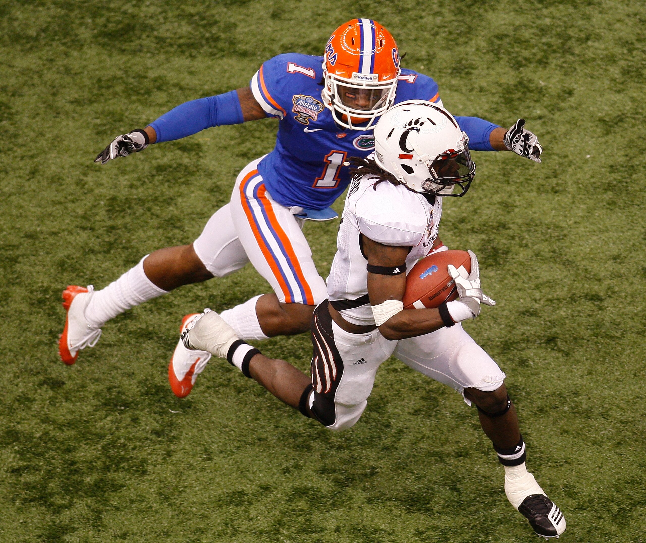 NEW ORLEANS - JANUARY 01: Mardy Gilyard #1 of the Cincinnati Bearcats is tackled by Janoris Jenkins #1 of the Florida Gators during the Allstate Sugar Bowl at the Louisana Superdome on January 1, 2010 in New Orleans, Louisiana. (Photo by Chris Graythen/ NEW ORLEANS - JANUARY 01: Mardy Gilyard #1 of the Cincinnati Bearcats is tackled by Janoris Jenkins #1 of the Florida Gators during the Allstate Sugar Bowl at the Louisana Superdome on January 1, 2010 in New Orleans, Louisiana. (Photo by Chris Graythen/