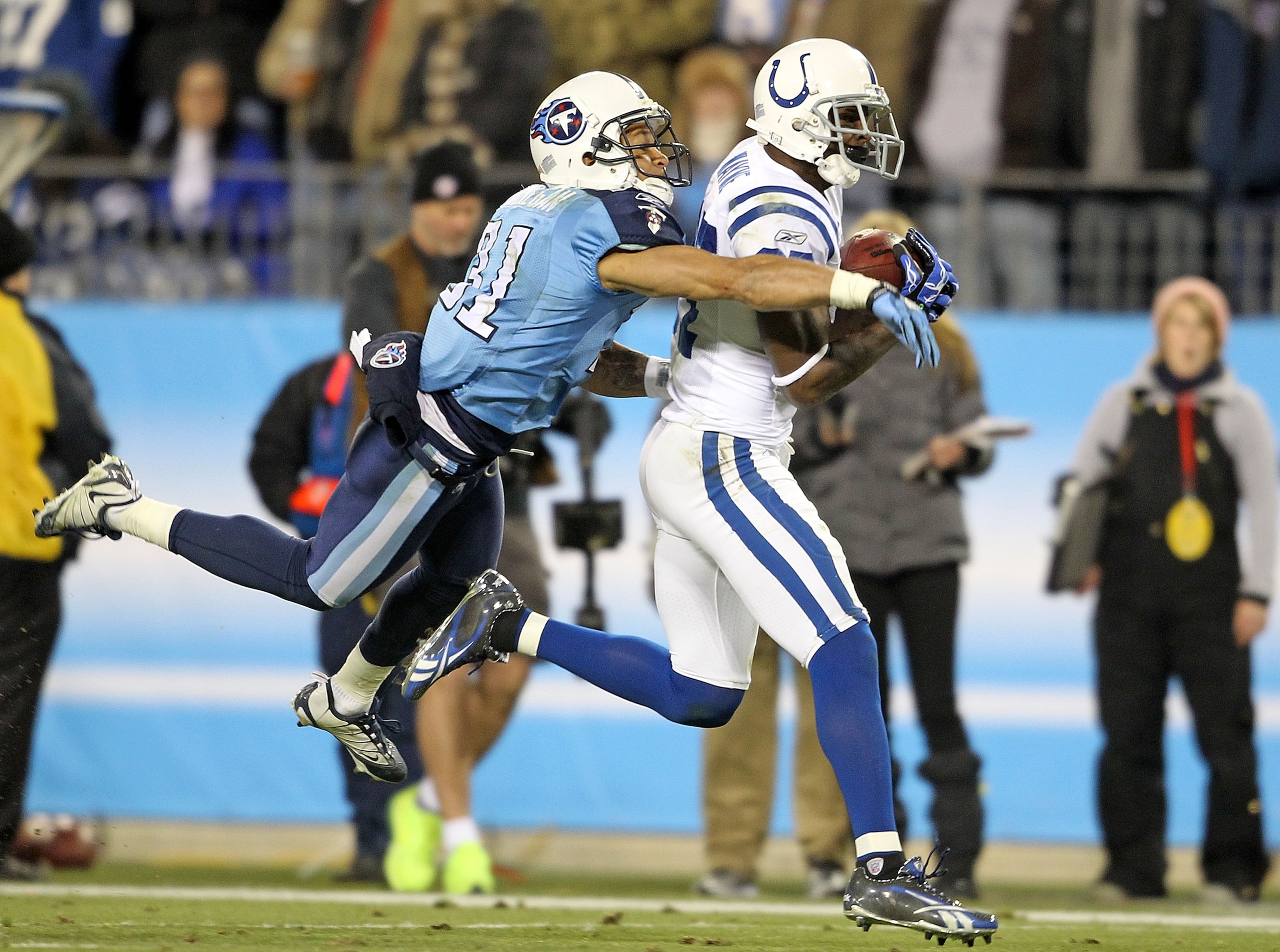 NASHVILLE, TN - DECEMBER 09: Reggie Wayne #87 of the Indianapolis Colts catches a pass while defended by Cortland Finnegan #31 of the Tennessee Titans during the NFL game at LP Field on December 9, 2010 in Nashville, Tennessee. (Photo by Andy Lyons/Get NASHVILLE, TN - DECEMBER 09: Reggie Wayne #87 of the Indianapolis Colts catches a pass while defended by Cortland Finnegan #31 of the Tennessee Titans during the NFL game at LP Field on December 9, 2010 in Nashville, Tennessee. (Photo by Andy Lyons/Get