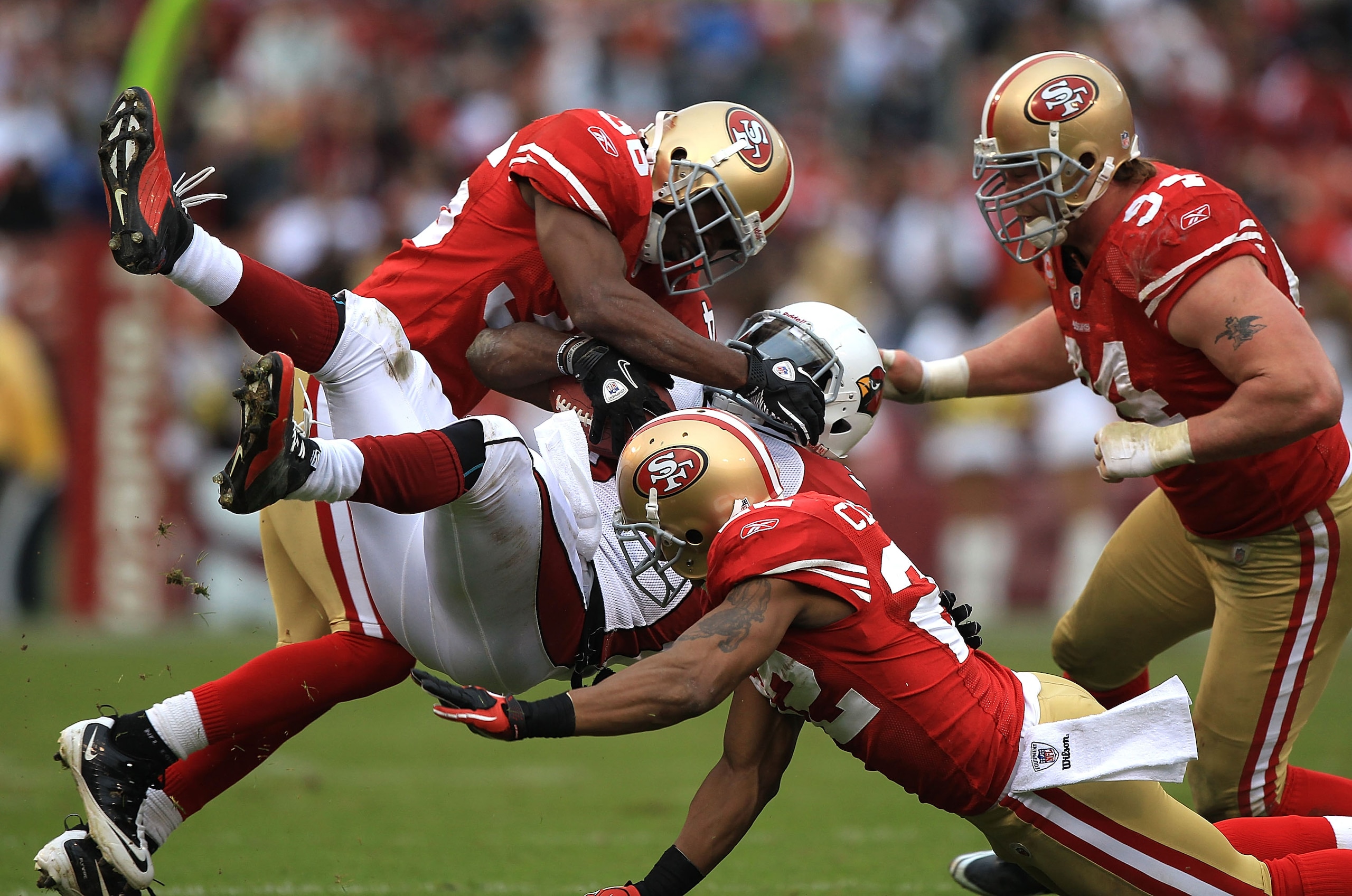 SAN FRANCISCO, CA - JANUARY 02: Tim Hightower #34 of the Arizona Cardinals is tackled by Nate Clements #22 and Shawntae Spencer #36 of the San Francisco 49ers during an NFL game at Candlestick Park on January 2, 2011 in San Francisco, California. (Ph SAN FRANCISCO, CA - JANUARY 02: Tim Hightower #34 of the Arizona Cardinals is tackled by Nate Clements #22 and Shawntae Spencer #36 of the San Francisco 49ers during an NFL game at Candlestick Park on January 2, 2011 in San Francisco, California. (Ph