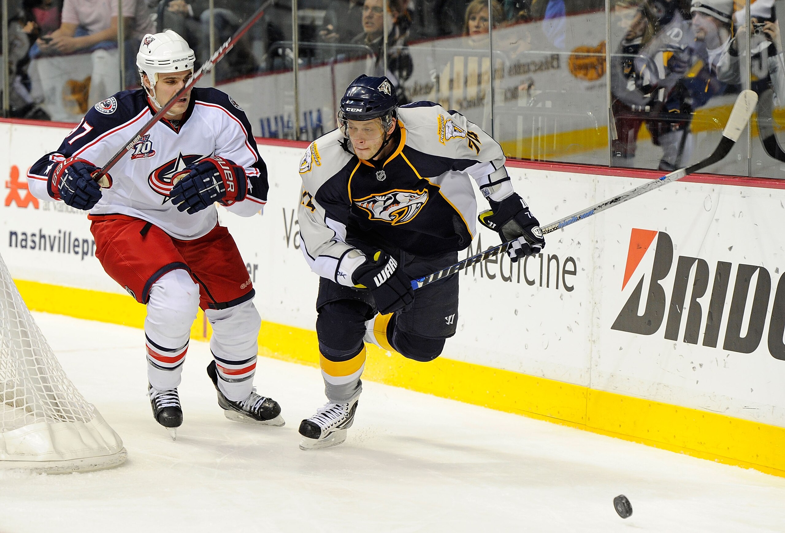 NASHVILLE, TN - JANUARY 02:  Sergei Kostitsyn #74 of the Nashville Predators skates against Rostislav Klesla #97 of the Columbus Blue Jackets on January 2, 2011 at the Bridgestone Arena in Nashville, Tennessee.  (Photo by Frederick Breedon/Getty Images)