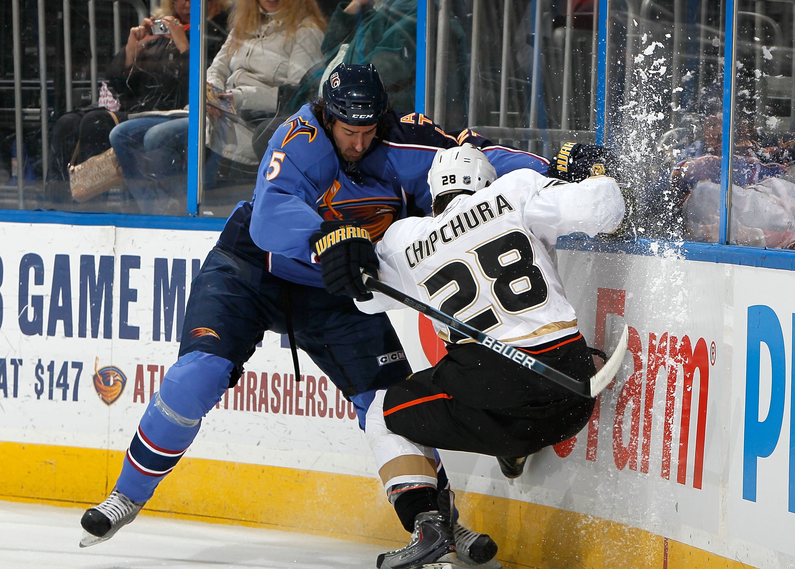 ATLANTA - JANUARY 26:  Kyle Chipchura #28 of the Anaheim Ducks is checked into the boards by Boris Valabik #5 of the Atlanta Thrashers at Philips Arena on January 26, 2010 in Atlanta, Georgia.  (Photo by Kevin C. Cox/Getty Images)