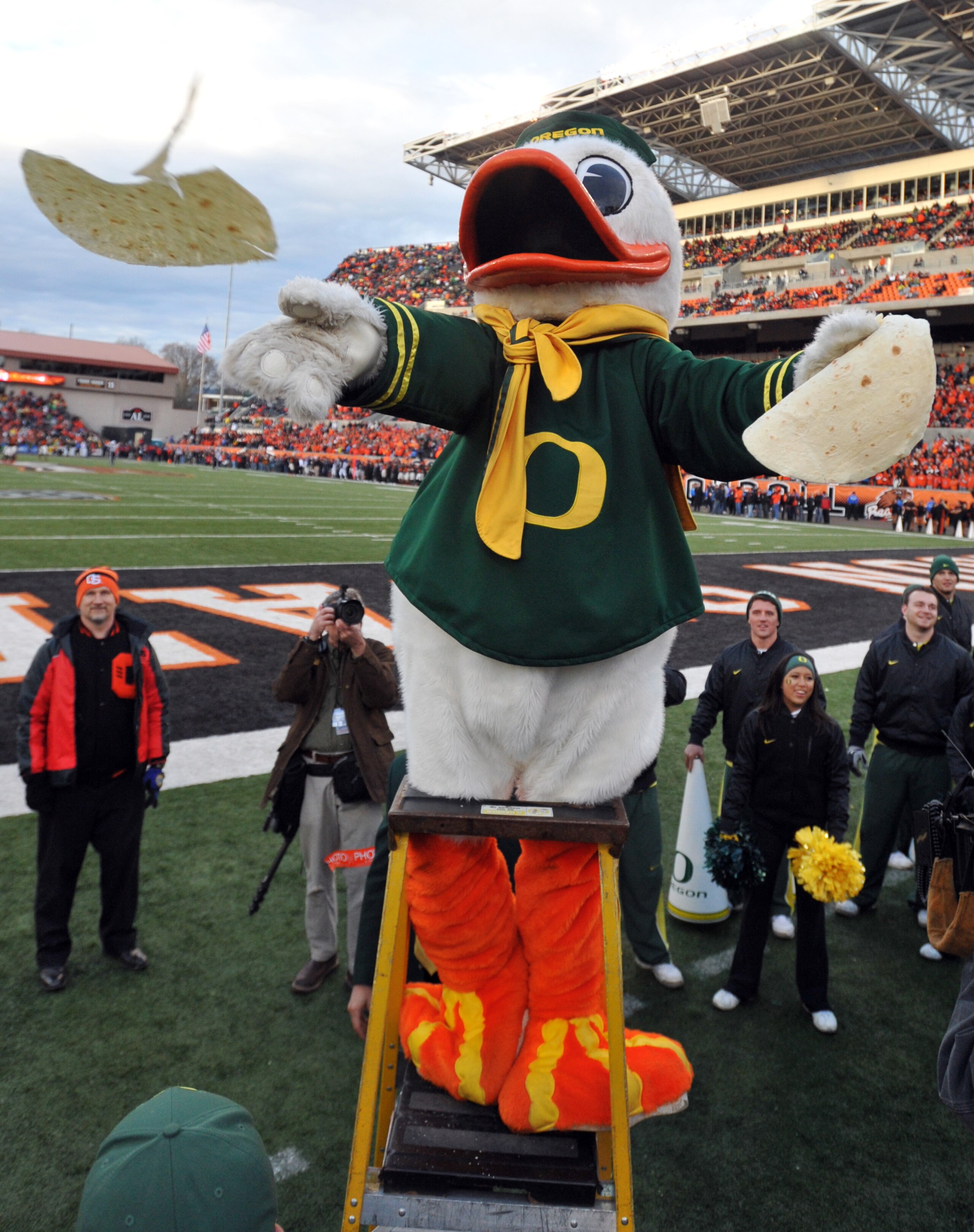 CORVALLIS, OR - DECEMBER 4: Oregon Ducks mascot 'Puddles' tosses some tortillas into the crowd as time winds down in the fourth quarter of the game against the Oregon State Beavers at Reser Stadium on December 4, 2010 in Corvallis, Oregon. The Ducks beat