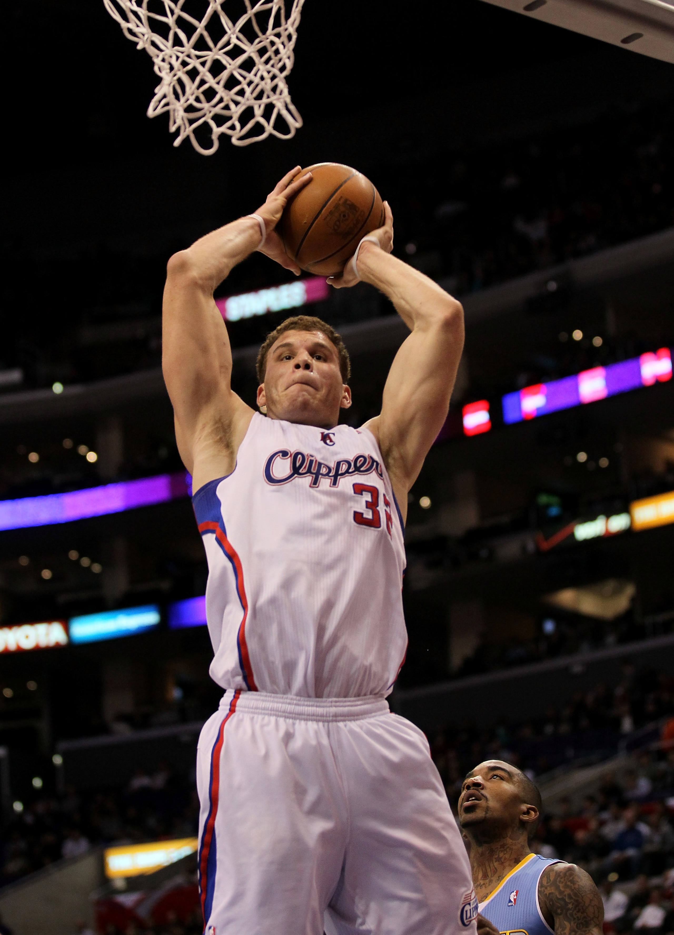 LOS ANGELES, CA - JANUARY 05: Blake Griffin #32 of the Los Angeles Clippers grabs a rebound against the Denver Nuggets at Staples Center on January 5, 2011 in Los Angeles, California. The Clippers won 106-93. NOTE TO USER: User expressly acknowledges a LOS ANGELES, CA - JANUARY 05: Blake Griffin #32 of the Los Angeles Clippers grabs a rebound against the Denver Nuggets at Staples Center on January 5, 2011 in Los Angeles, California. The Clippers won 106-93. NOTE TO USER: User expressly acknowledges a