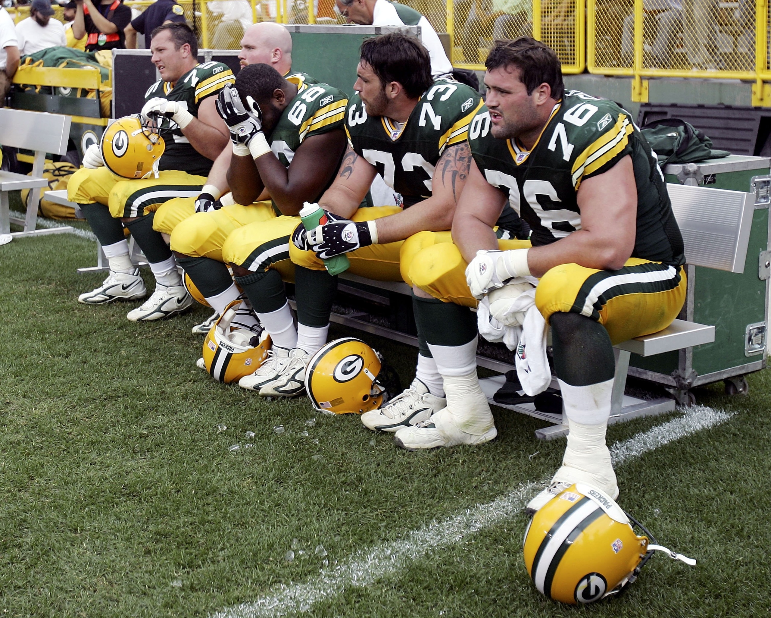 GREEN BAY, WI - SEPTEMBER 17:  The offensive line of the Green Bay Packers sits dejected in the final minutes of the game against the New Orleans Saints on September 17, 2006 at Lambeau Field in Green Bay, Wisconsin. The New Orleans Saints defeated the Gr