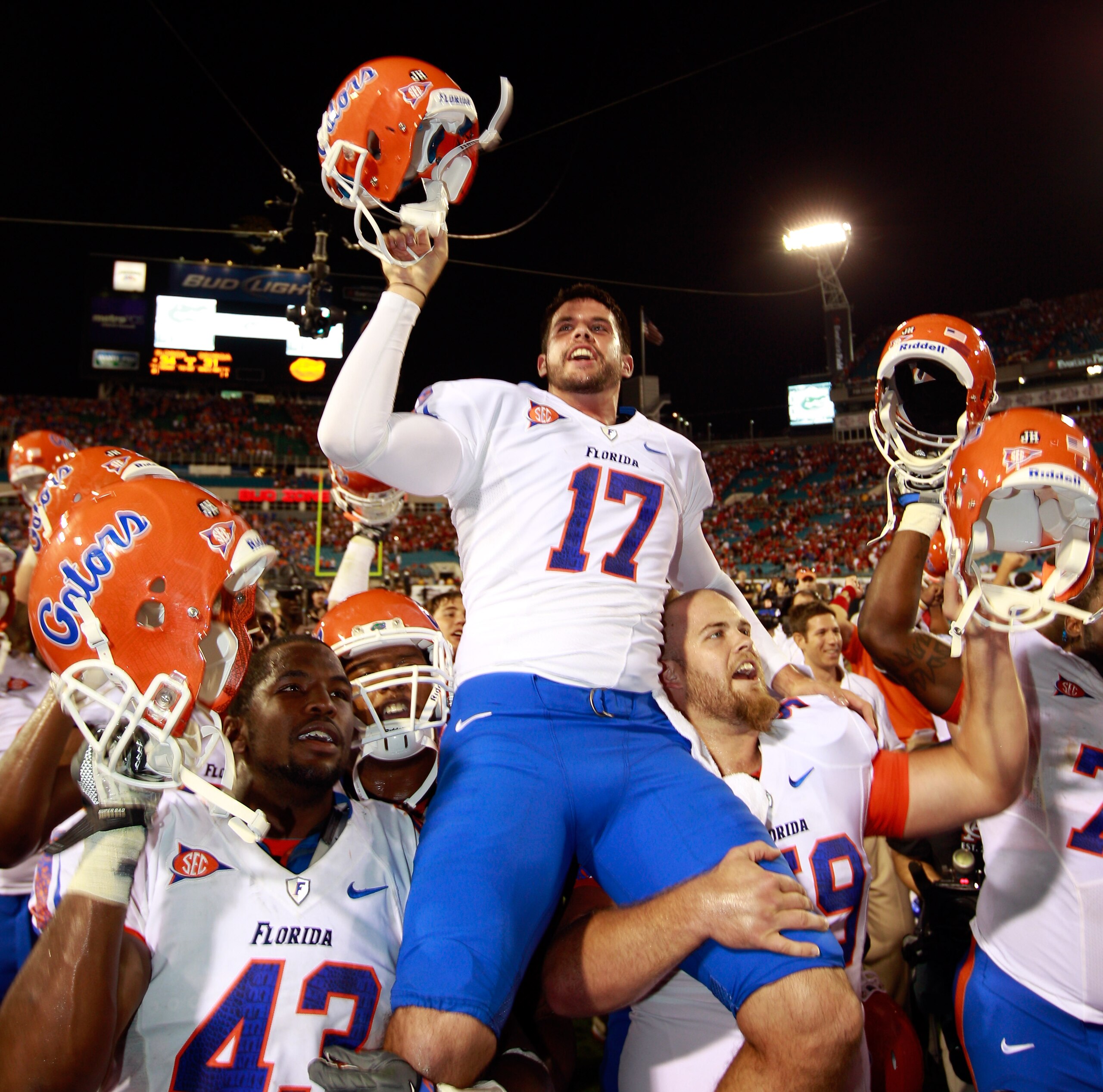 JACKSONVILLE, FL - OCTOBER 30:  Chas Henry #17 of the Florida Gators raises his helmet in vicrtory following the game against the Georgia Bulldogs at EverBank Field on October 30, 2010 in Jacksonville, Florida.  (Photo by Sam Greenwood/Getty Images)