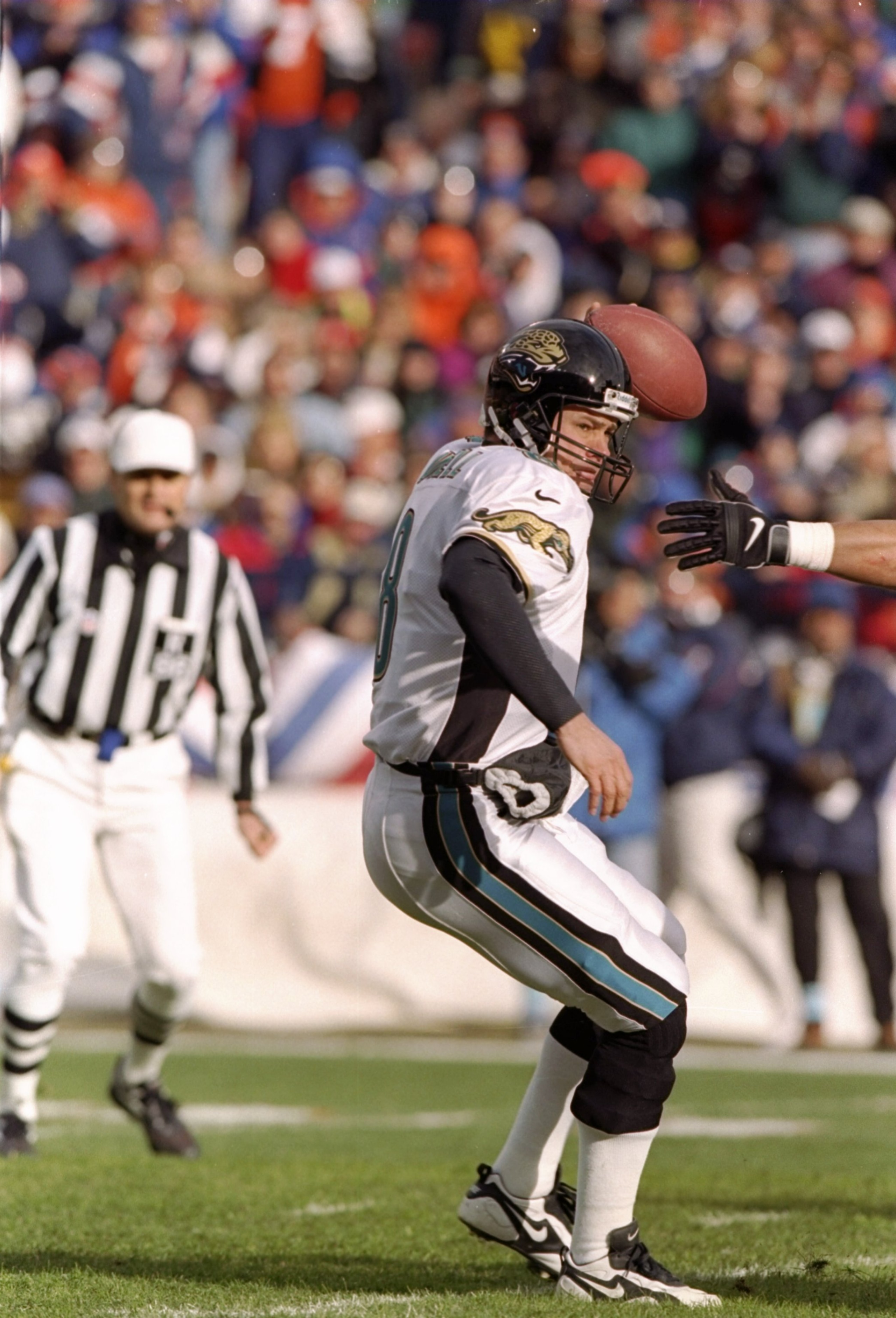 27 Dec 1997:  Quarterback Mark Brunell of the Jacksonville Jaguars tries to avoid the pressure during a game against the Denver Broncos at Mile High Stadium in Denver, Colorado.  Denver won the game 42-17. Mandatory Credit: Brian Bahr  /Allsport