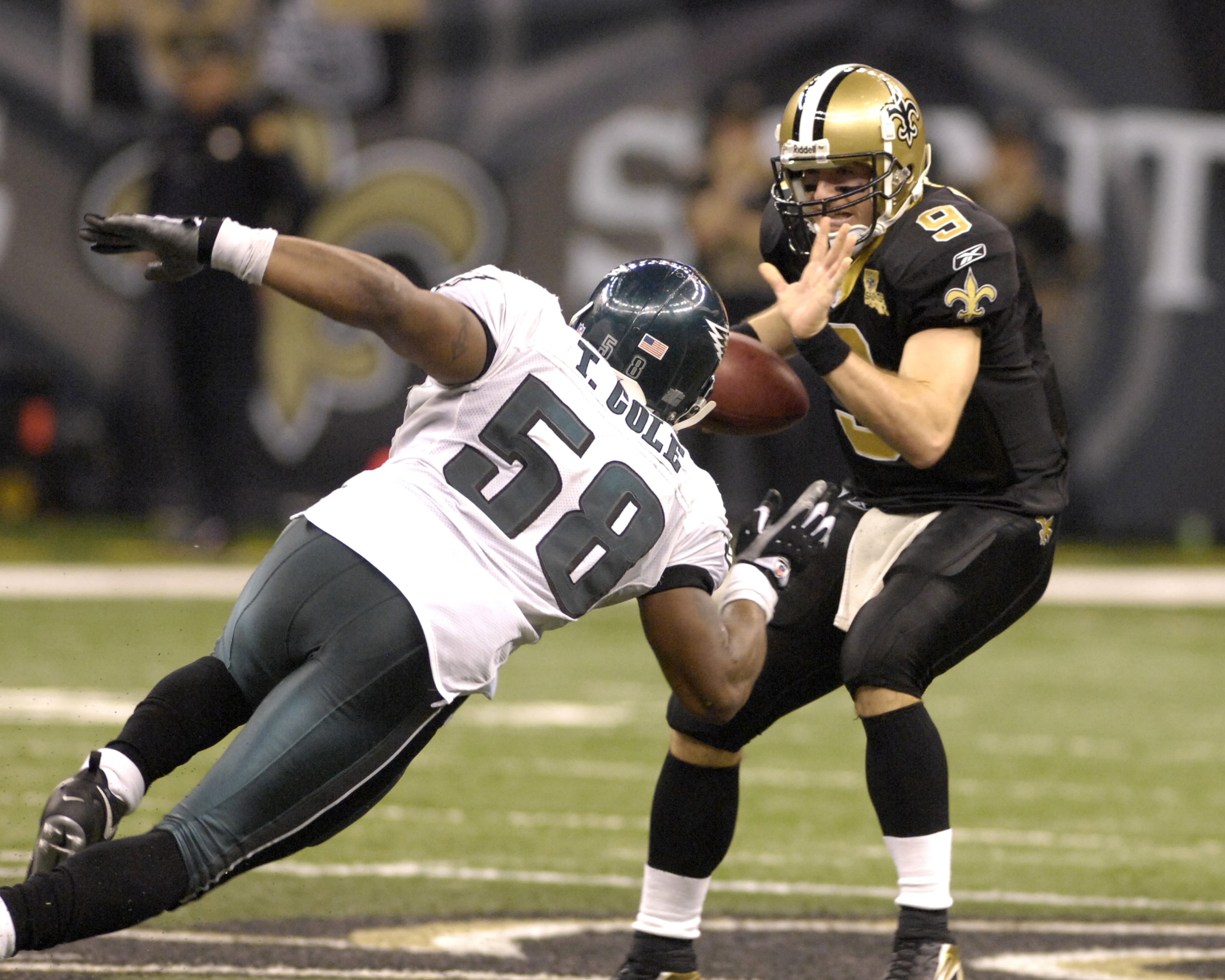 New Orleans Saints quarterback Drew Brees dodges Philadelphia Eagles linebacker Trent Cole during an NFL NFC divisional playoff game on January 13, 2007 in the Superdome in New Orleans, Louisiana. The Saints won 27 - 24. (Photo by Al Messerschmidt/Get New Orleans Saints quarterback Drew Brees dodges Philadelphia Eagles linebacker Trent Cole during an NFL NFC divisional playoff game on January 13, 2007 in the Superdome in New Orleans, Louisiana. The Saints won 27 - 24. (Photo by Al Messerschmidt/Get